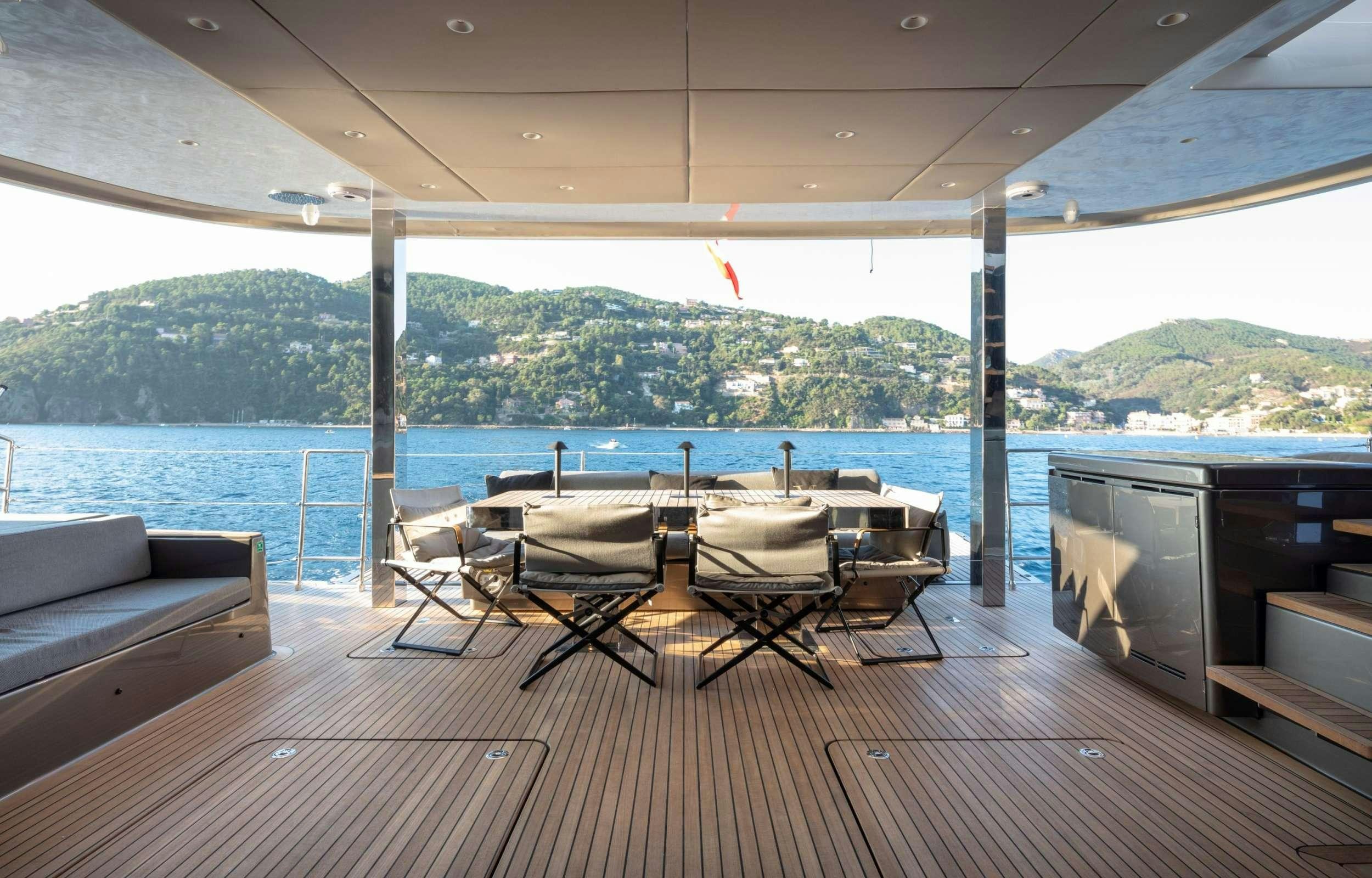 a deck with a table and chairs aboard ANIMA Yacht for Charter