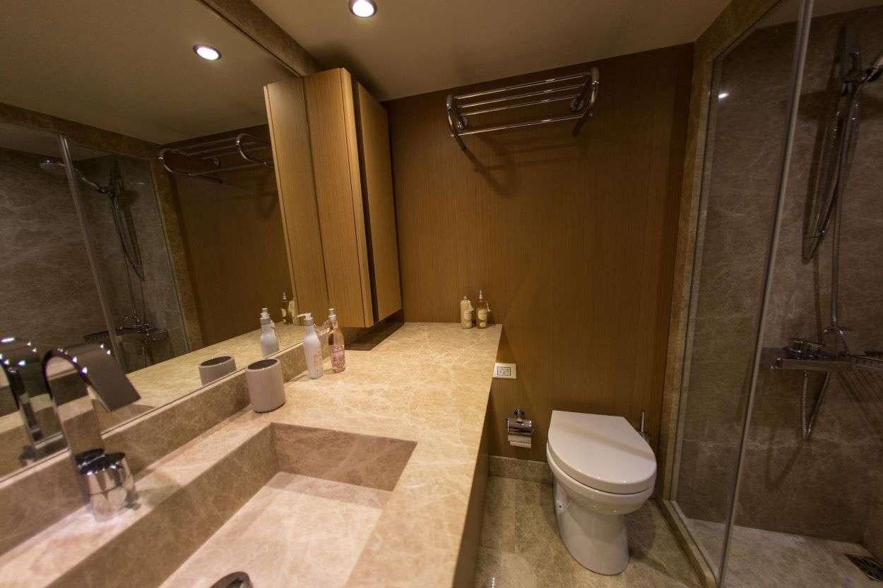 a bathroom with a glass shower aboard LE PIETRE Yacht for Charter