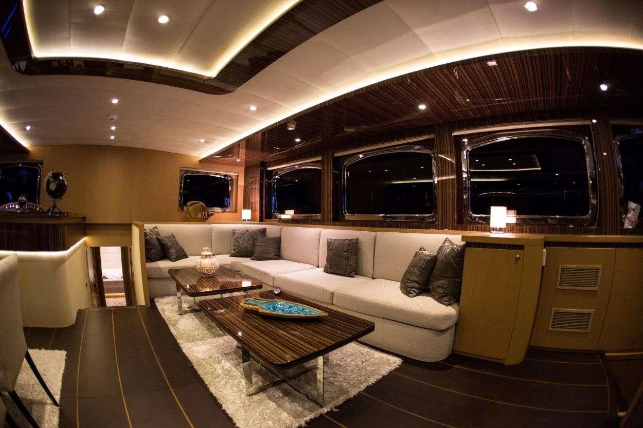 a living room with a couch and a fireplace aboard LE PIETRE Yacht for Charter