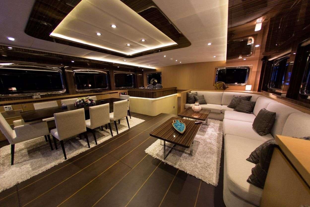 a living room with a large table and chairs aboard LE PIETRE Yacht for Charter