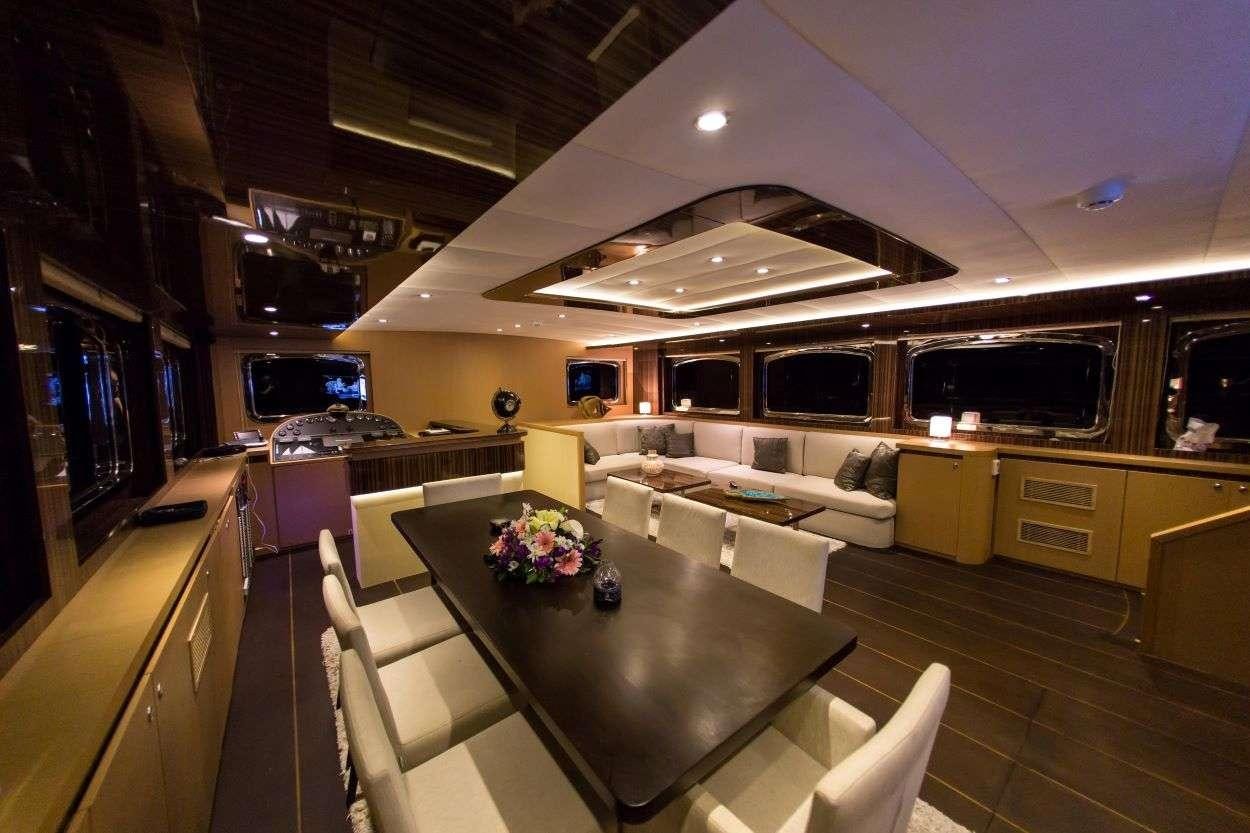 a living room with a large table aboard LE PIETRE Yacht for Charter