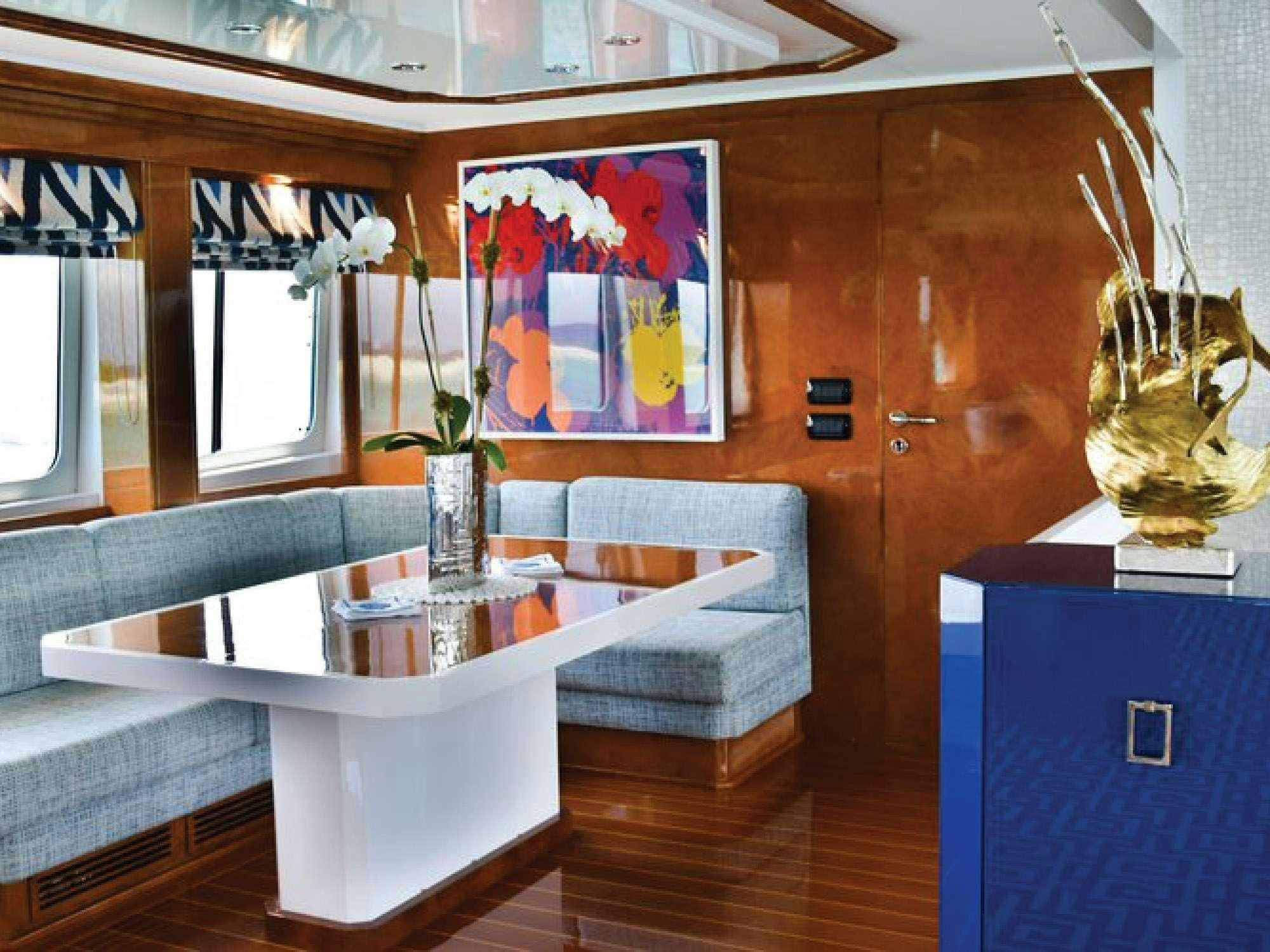 a room with a table and couch aboard OCTOPUSSY Yacht for Charter
