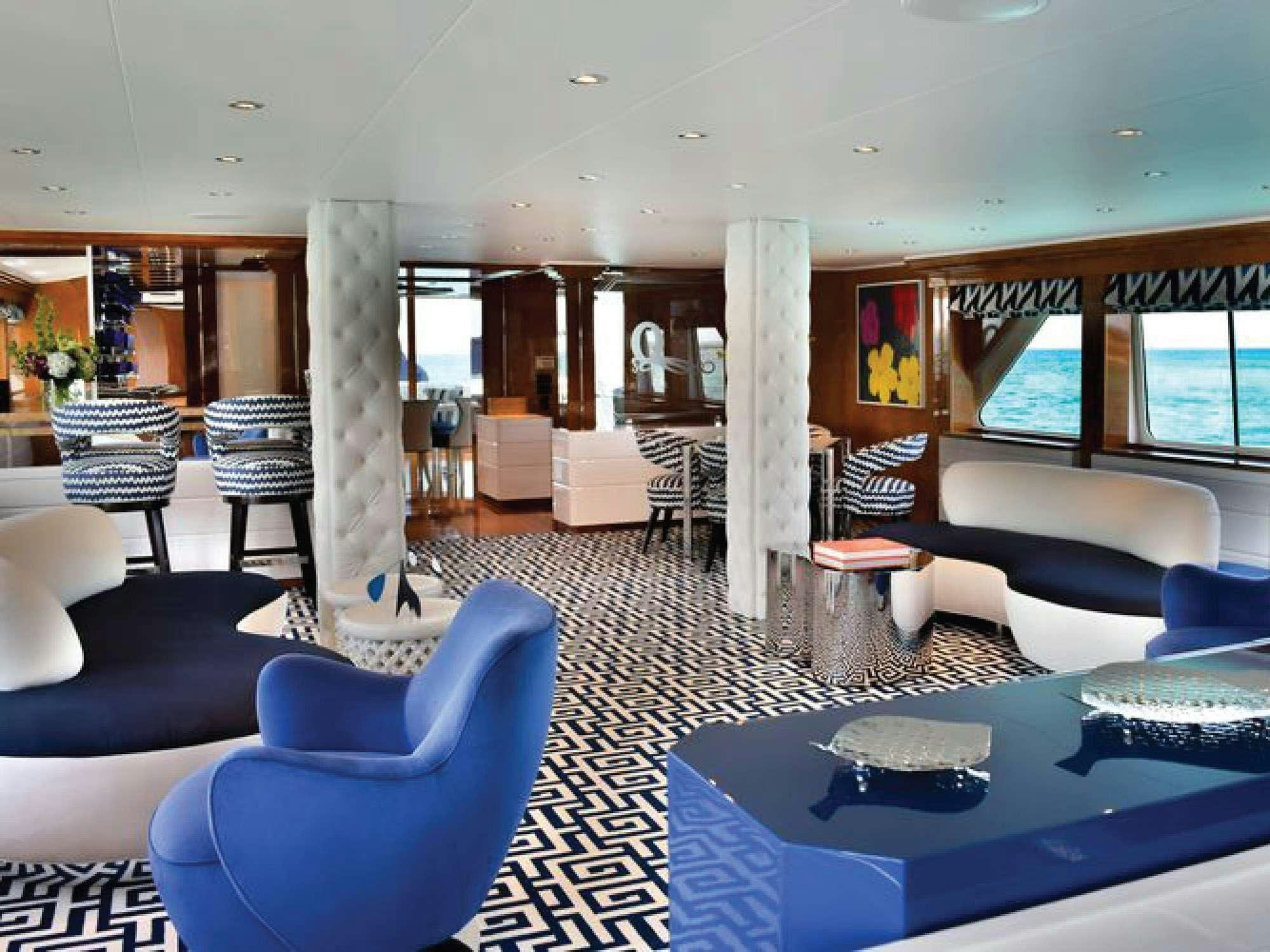 a large room with a pool table and chairs aboard OCTOPUSSY Yacht for Charter