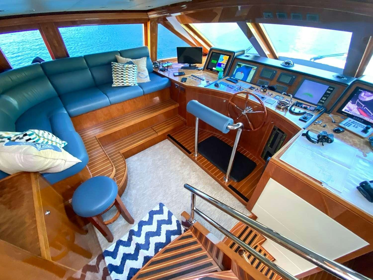 a living room with a couch and a television aboard CYNDERELLA Yacht for Charter