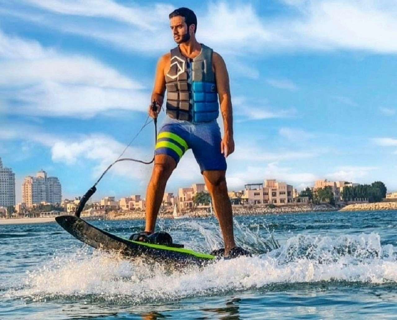 a man on a surfboard aboard CYNDERELLA Yacht for Charter