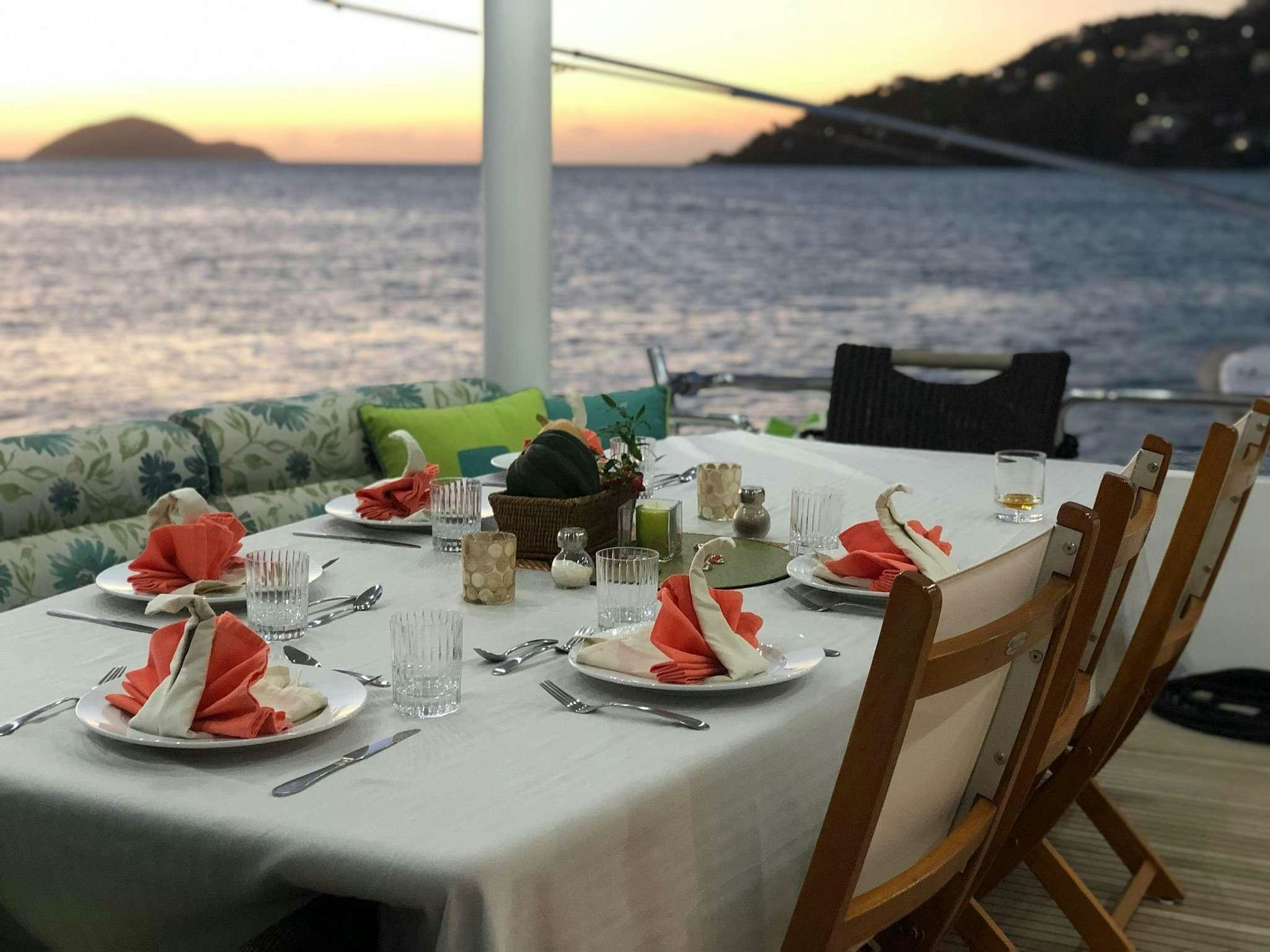 a table set with plates and food aboard CYNDERELLA Yacht for Charter