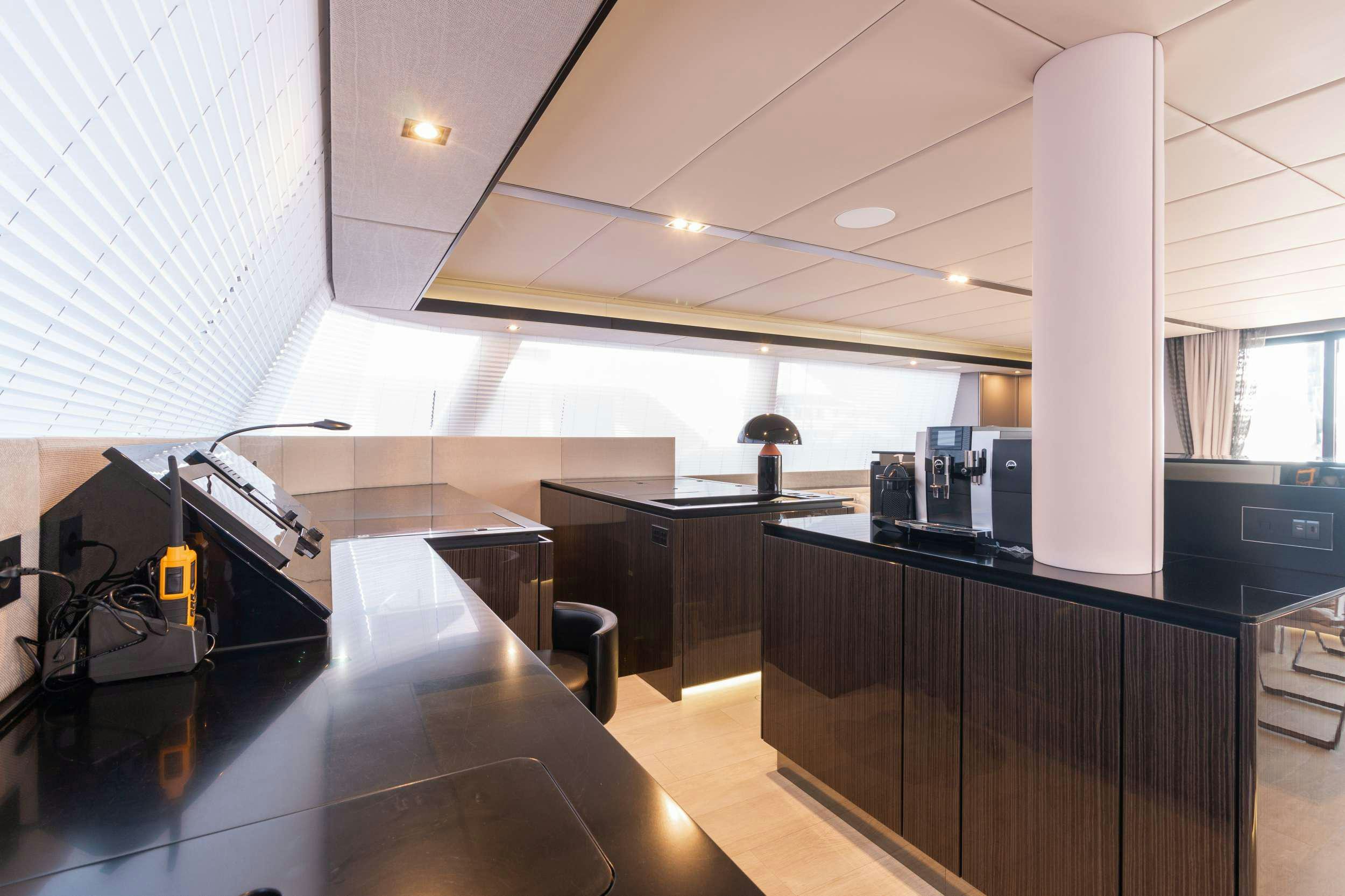 a large room with a large desk and a large white pillar aboard OCEAN VIBES Yacht for Charter