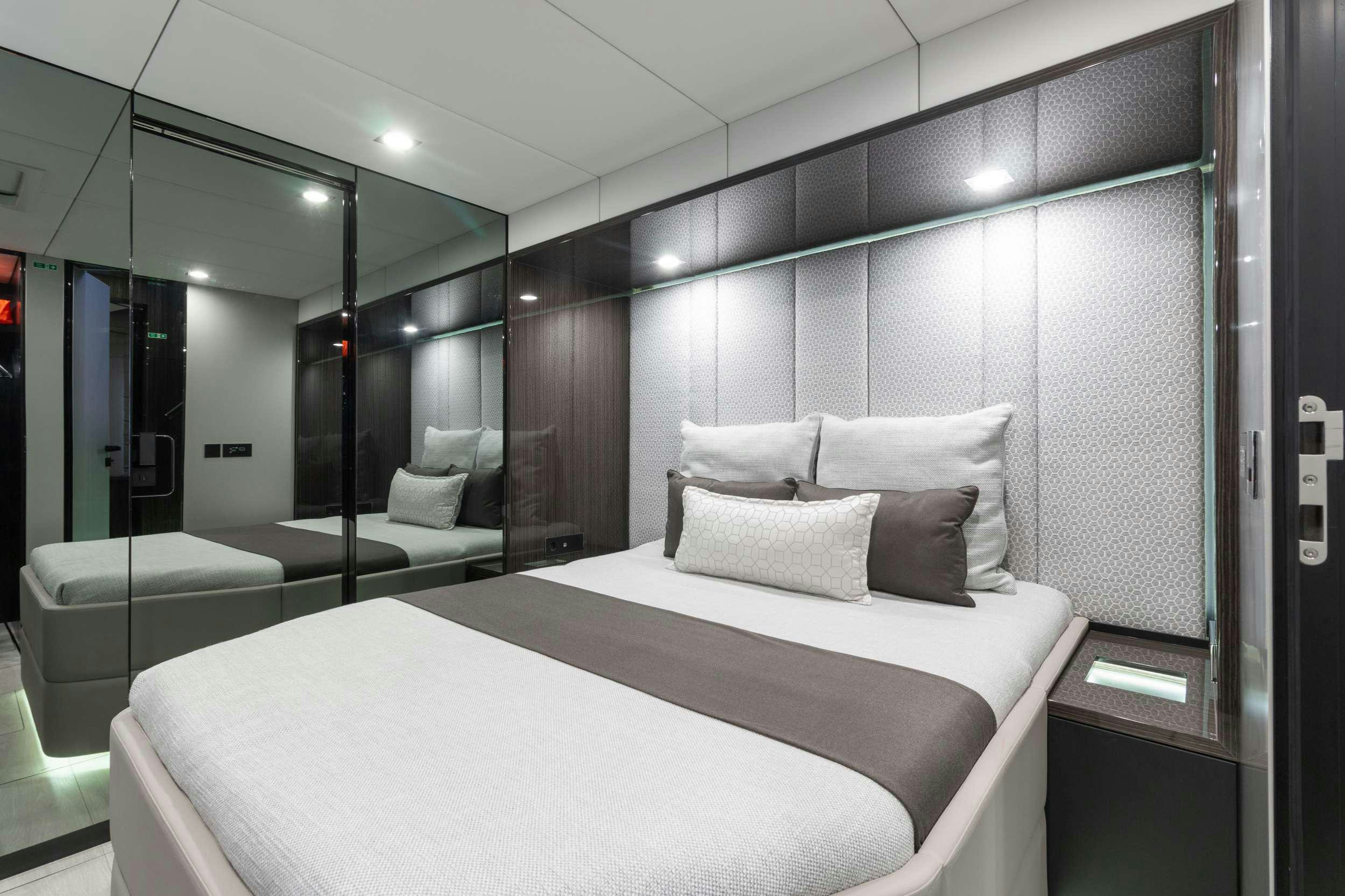 a room with a bed and a couch aboard OCEAN VIBES Yacht for Charter