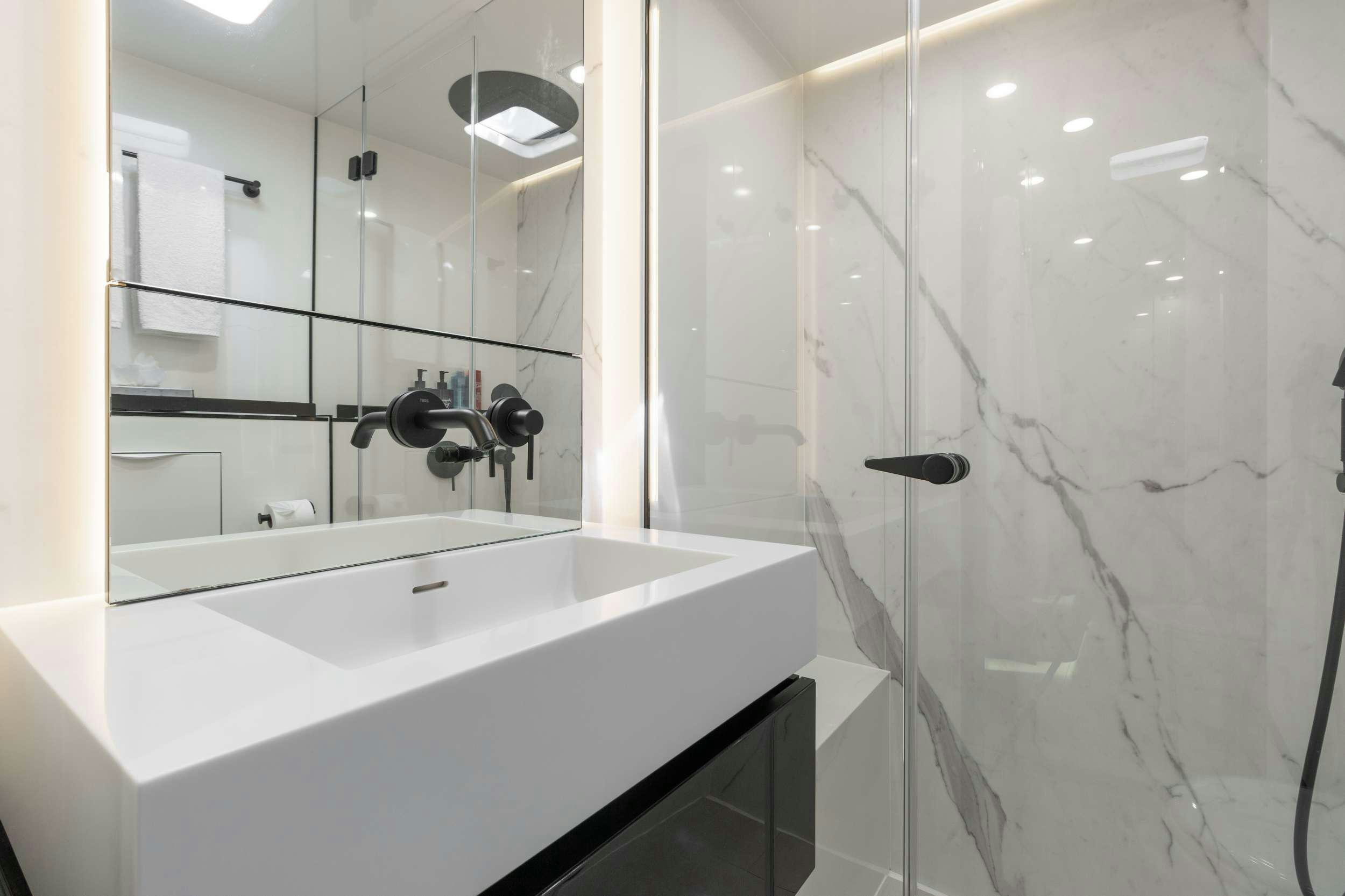 a bathroom with a bathtub and shower aboard OCEAN VIBES Yacht for Charter