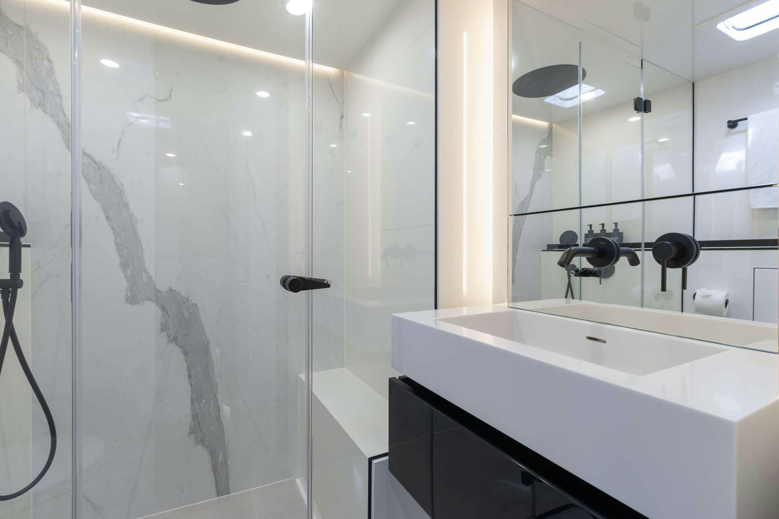 a bathroom with a shower and sink aboard OCEAN VIBES Yacht for Charter