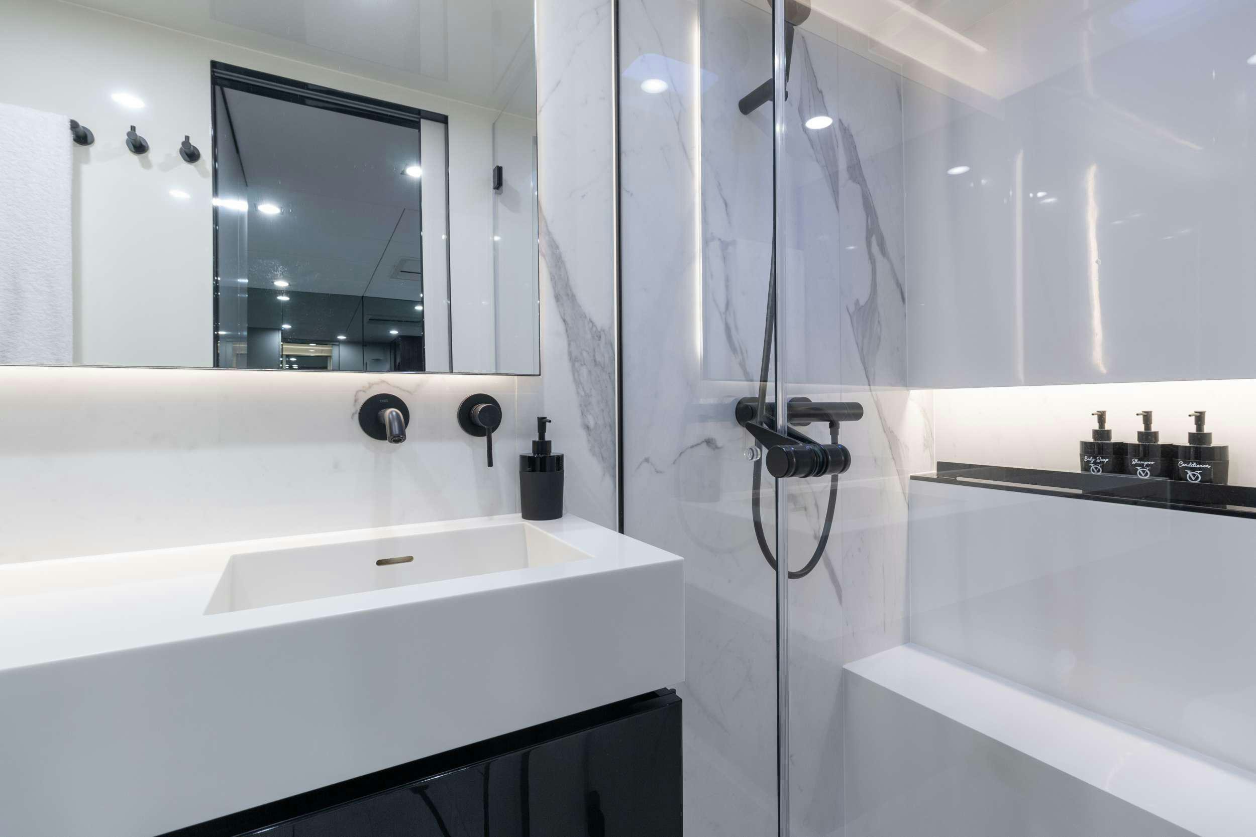 a bathroom with a sink and a mirror aboard OCEAN VIBES Yacht for Charter