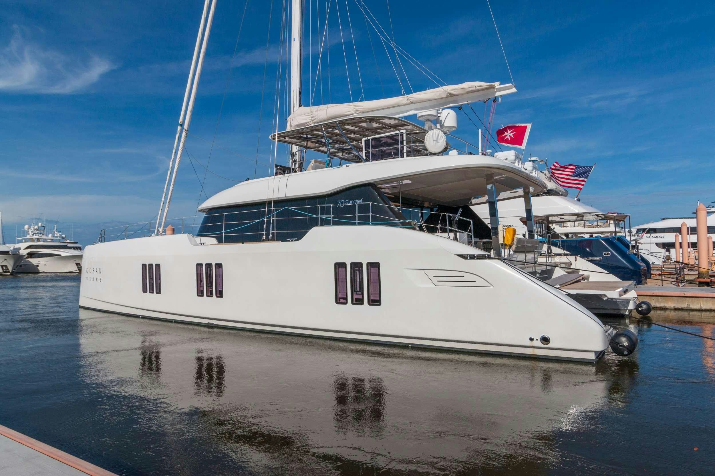 a large white boat in a harbor aboard OCEAN VIBES Yacht for Charter