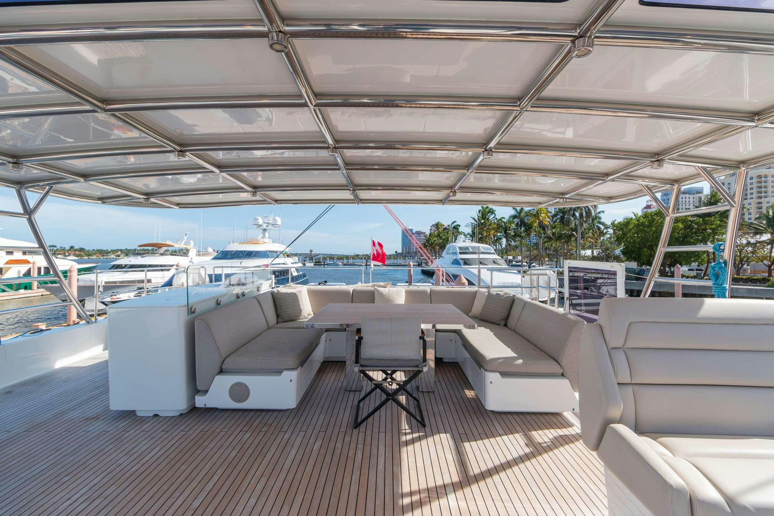a deck with couches and chairs aboard OCEAN VIBES Yacht for Charter