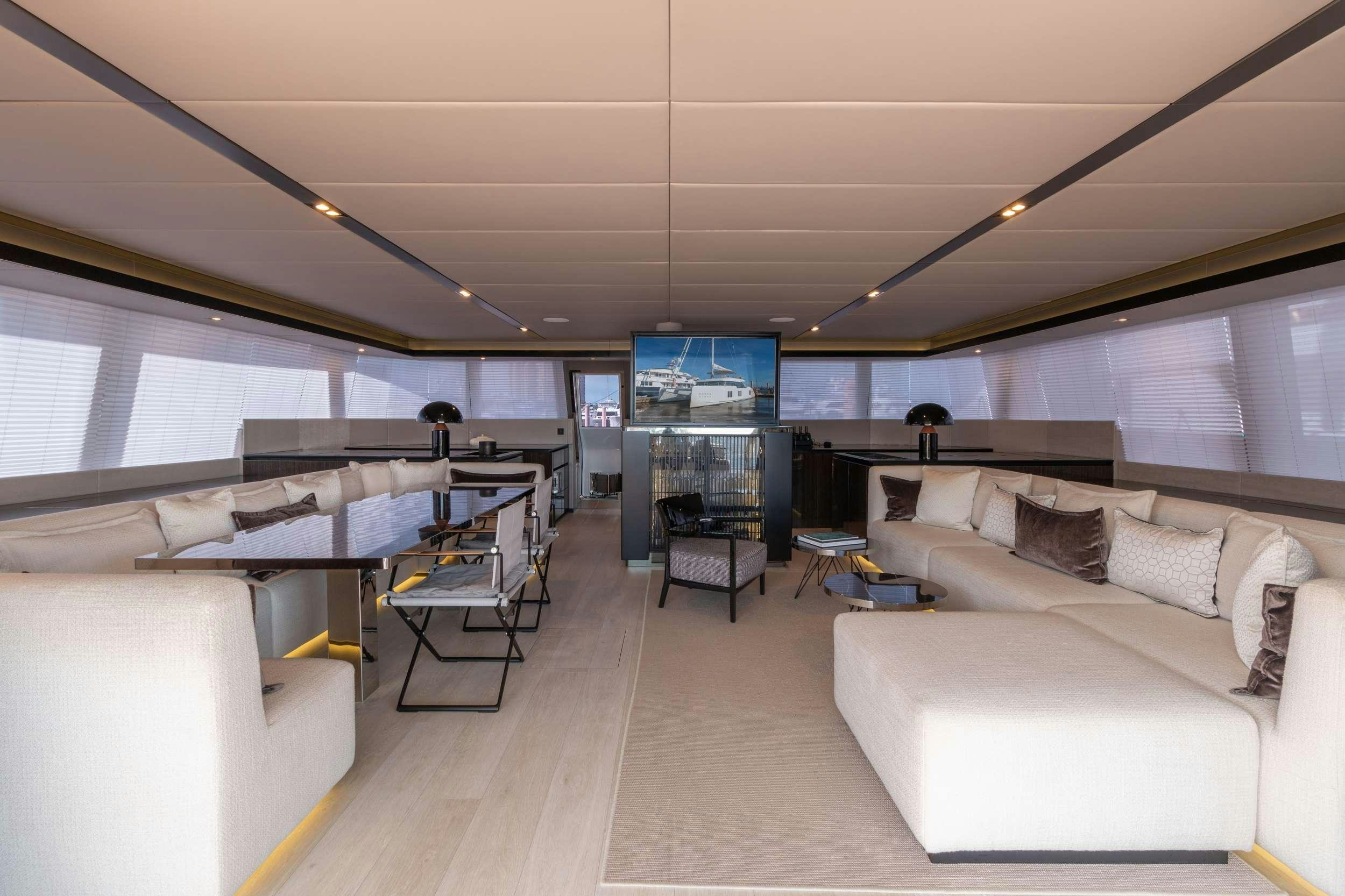 a room with a couch and a table aboard OCEAN VIBES Yacht for Charter