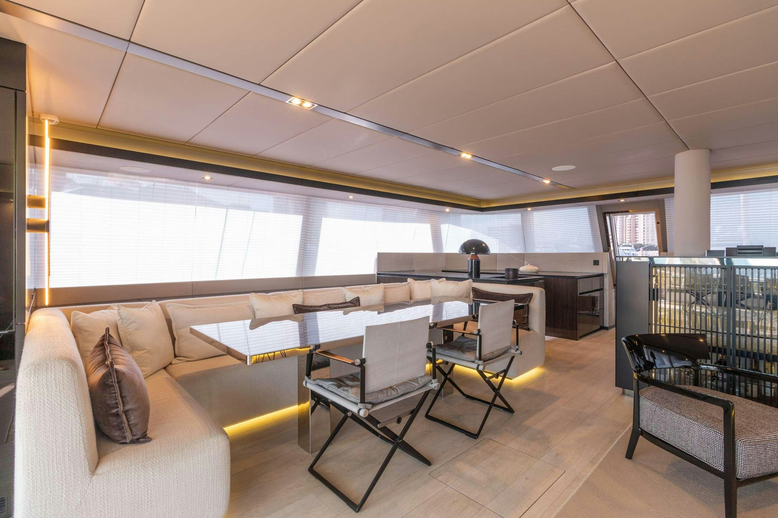 a room with a couch and a table and chairs aboard OCEAN VIBES Yacht for Charter
