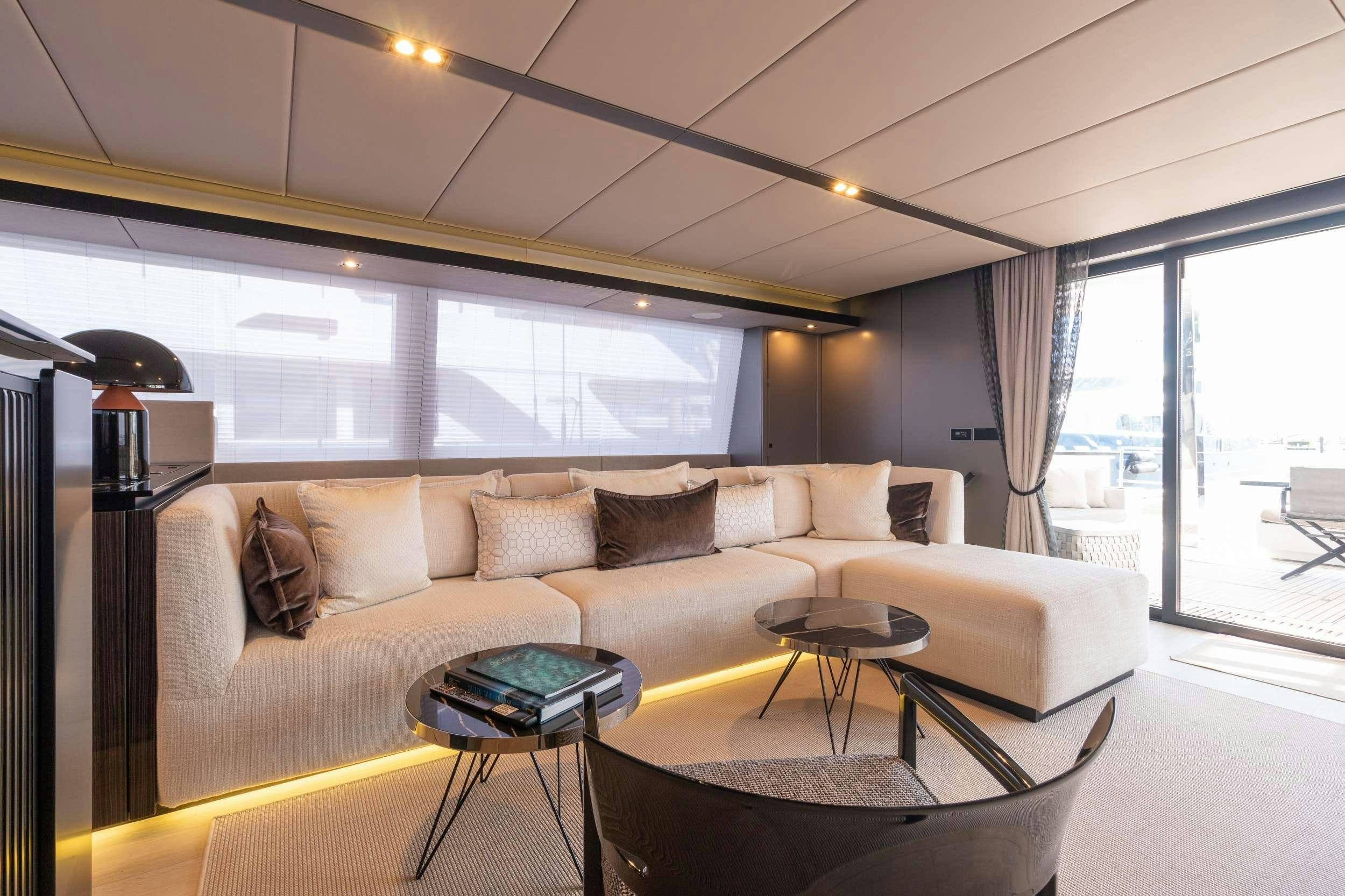 a living room with a couch and a table aboard OCEAN VIBES Yacht for Charter