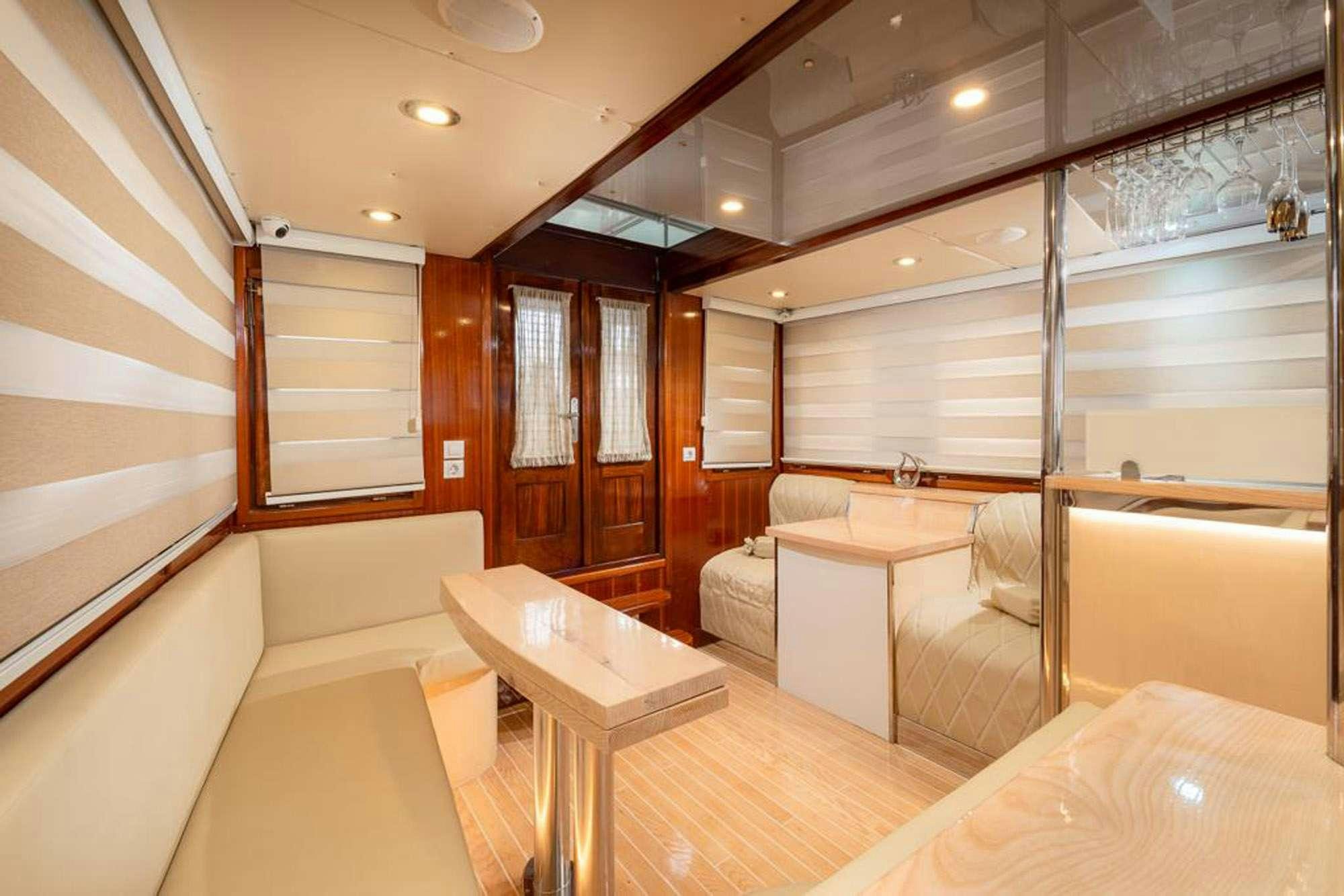 a room with a table and chairs aboard SLANO Yacht for Charter