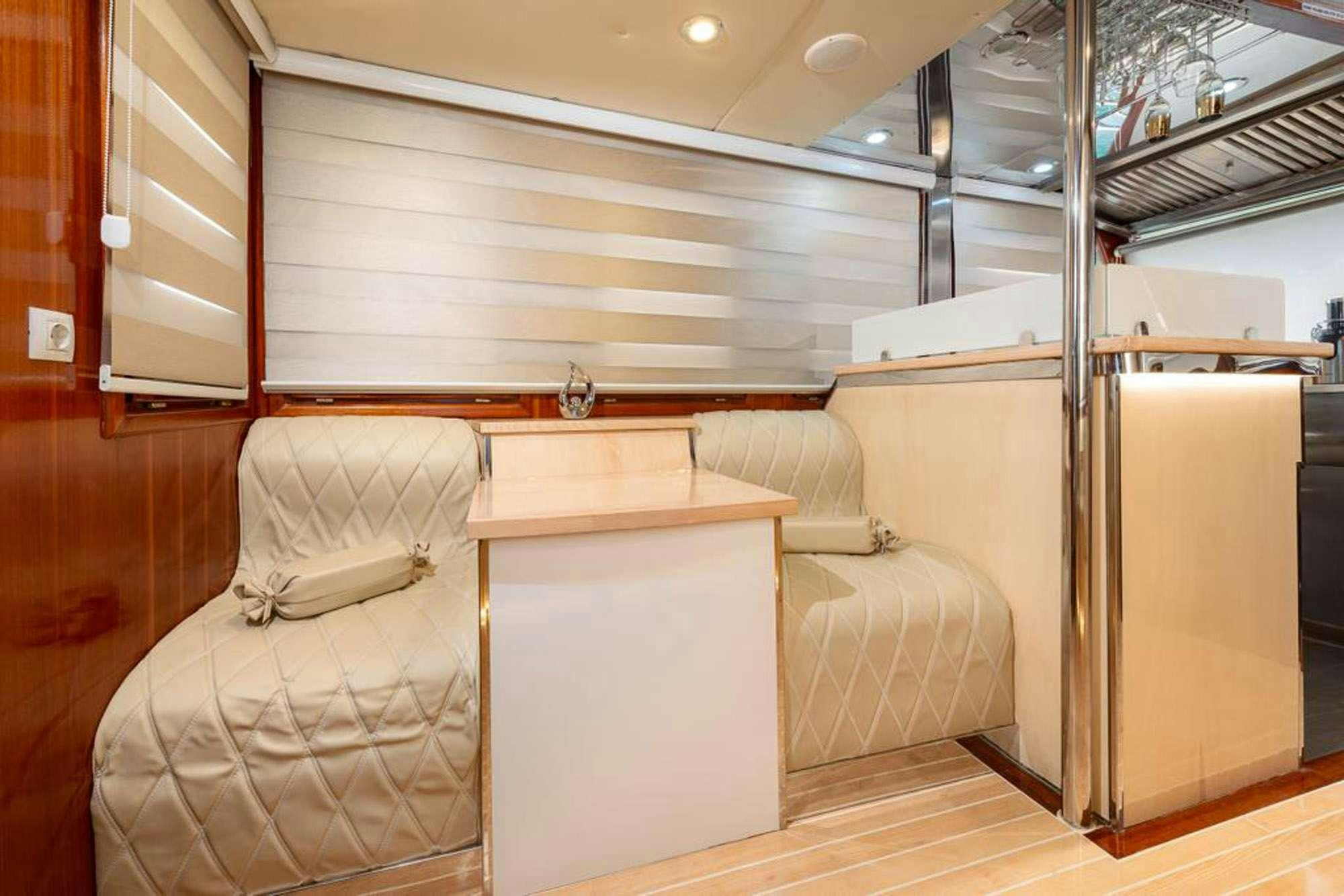 a room with a couch and a table aboard SLANO Yacht for Charter