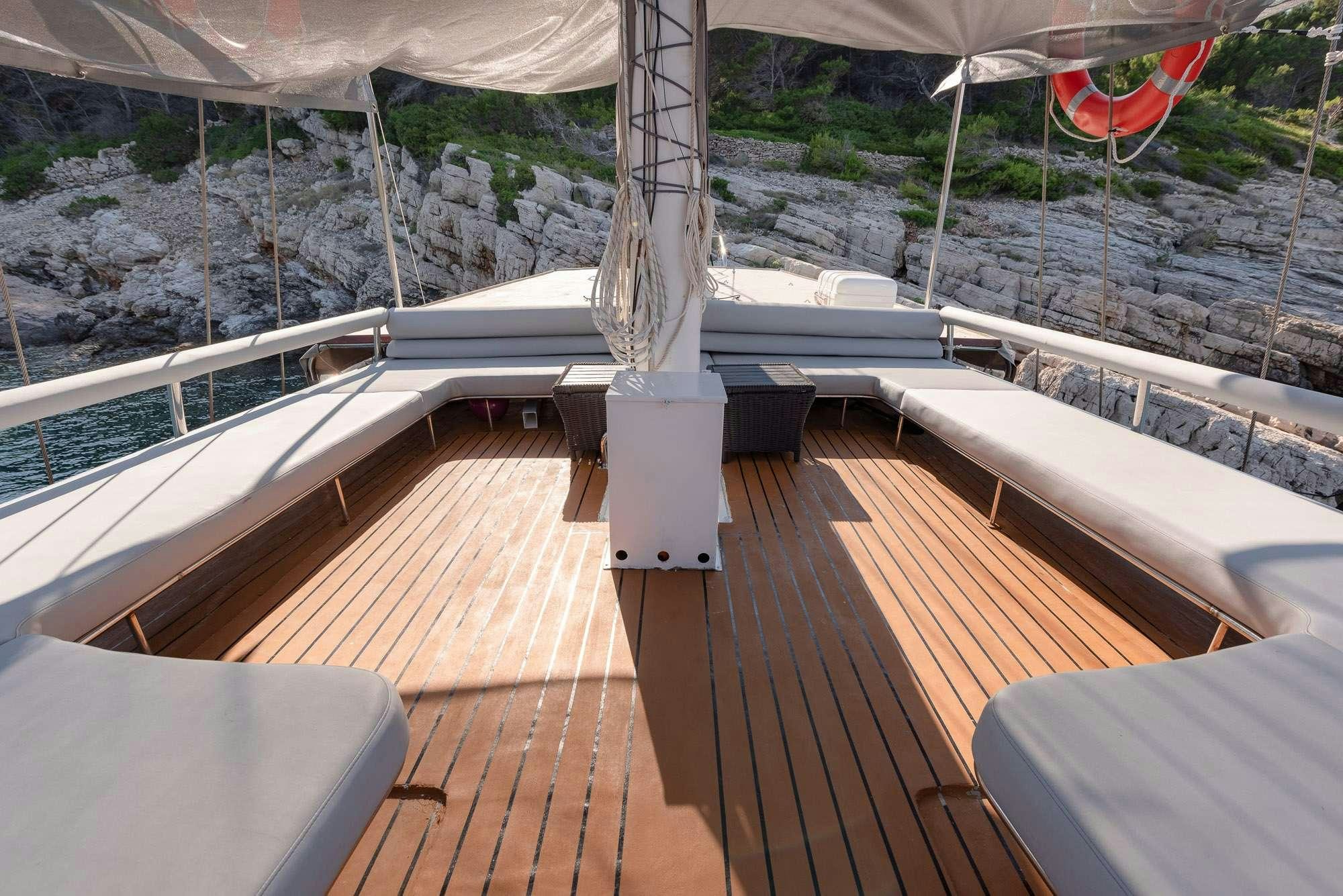 a deck with a view of a city and a river aboard SLANO Yacht for Charter