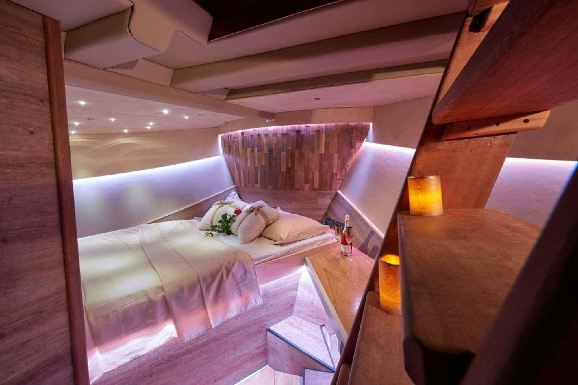 a room with a bed and a table aboard SLANO Yacht for Charter