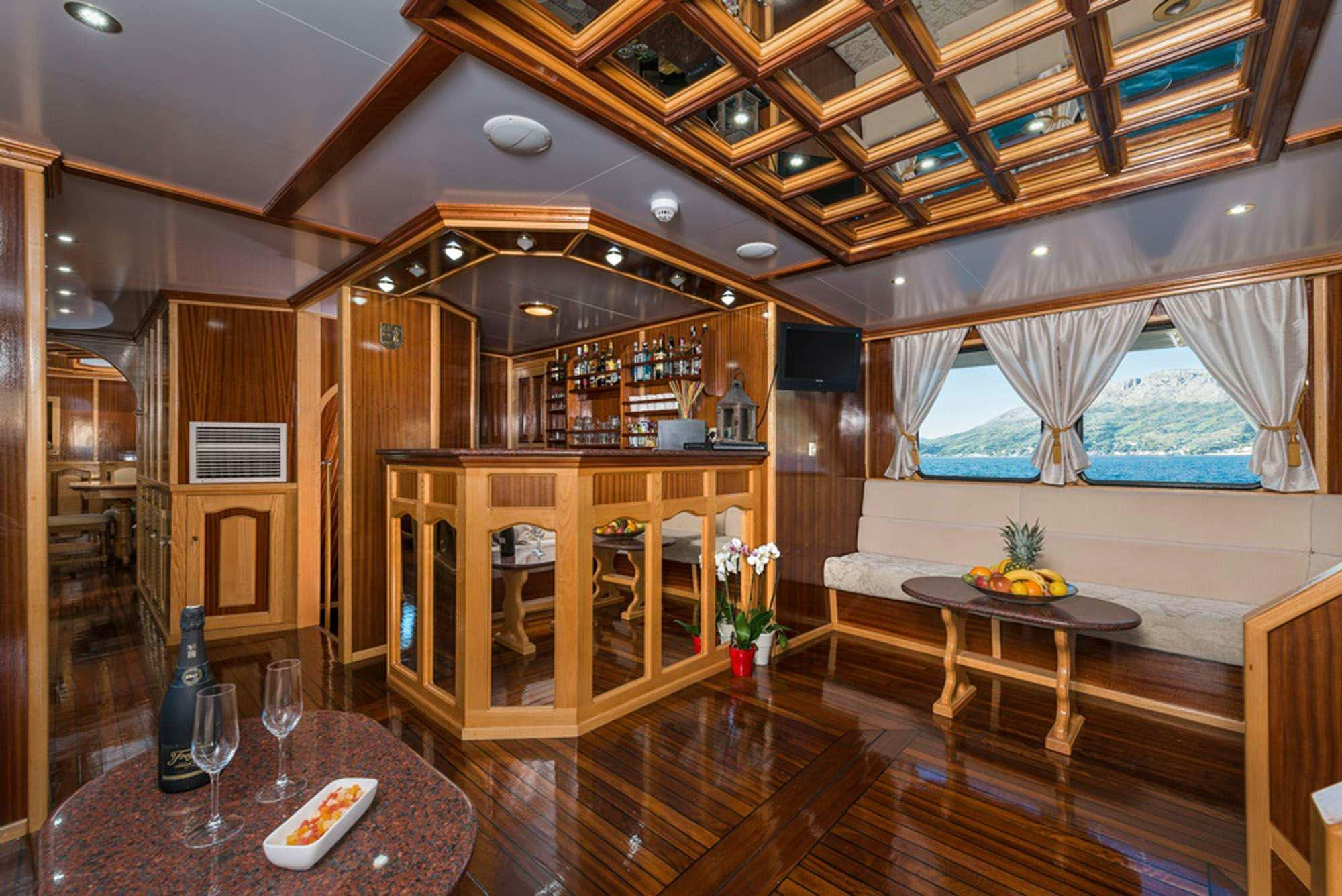 a room with a table and chairs aboard KORAB Yacht for Charter