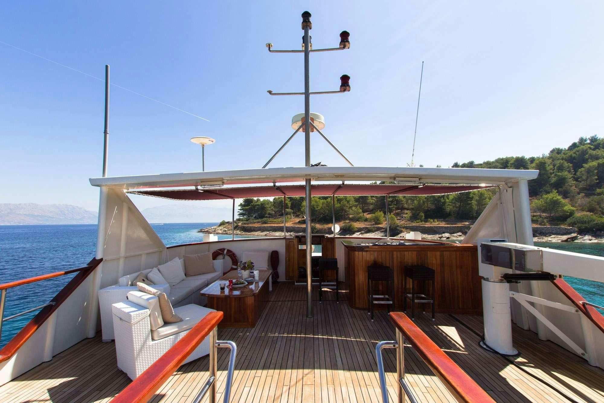 a deck with a large body of water and a large tower with a structure on it aboard KORAB Yacht for Charter