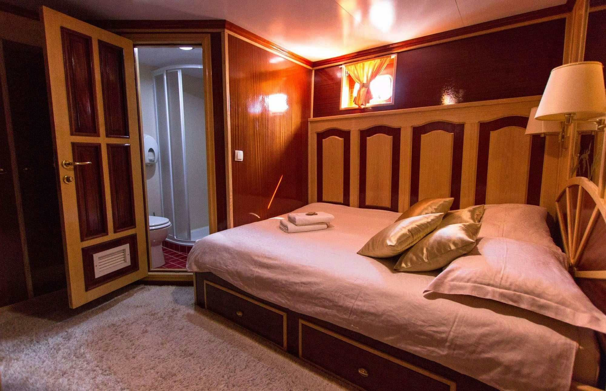 a hotel room with a bed aboard KORAB Yacht for Charter