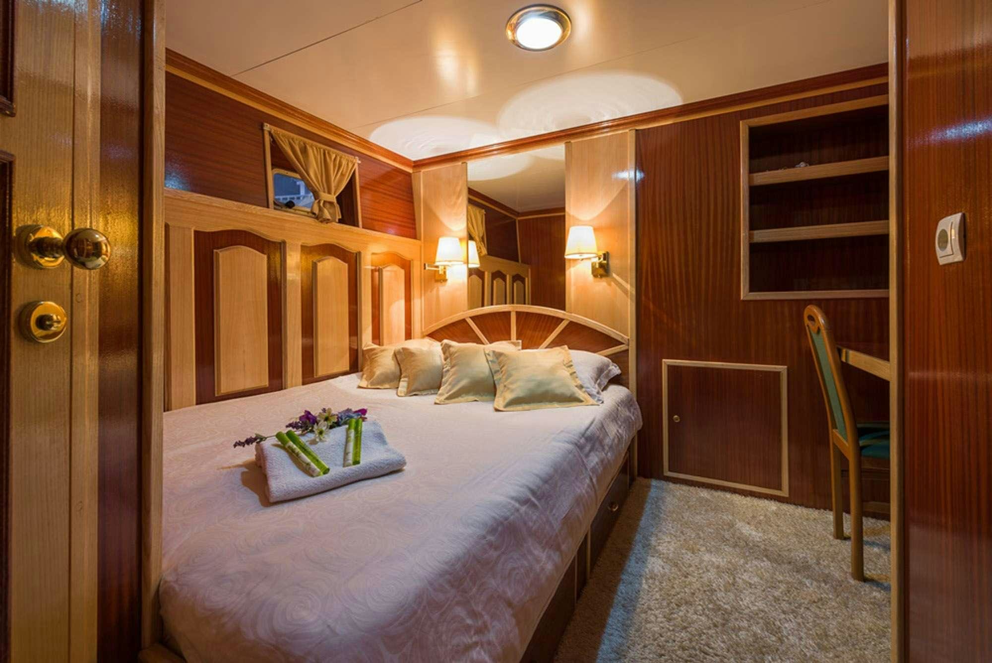 a bed with a tray on it aboard KORAB Yacht for Charter