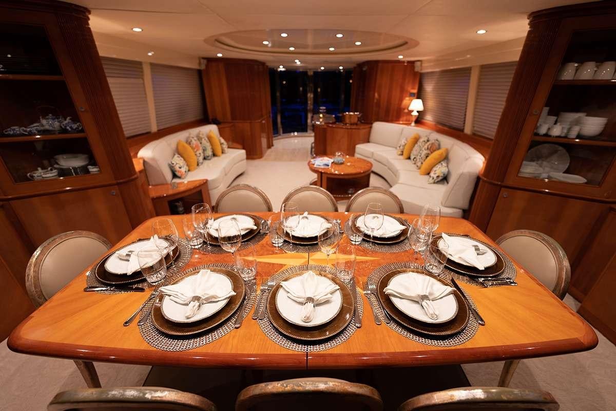 a dining table with plates and glasses aboard ENDLESS SUN Yacht for Charter