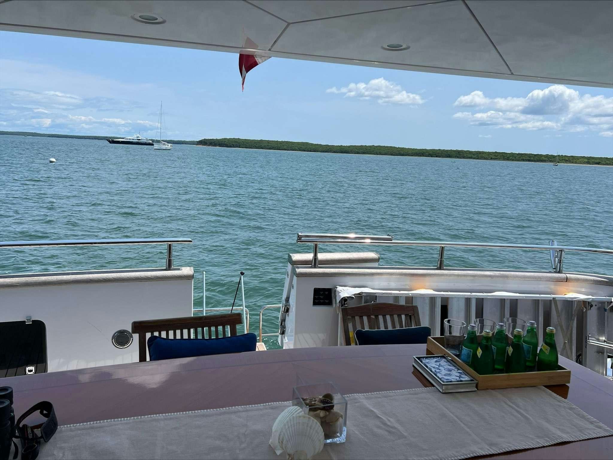 a table with chairs on it by the water aboard ENDLESS SUN Yacht for Charter