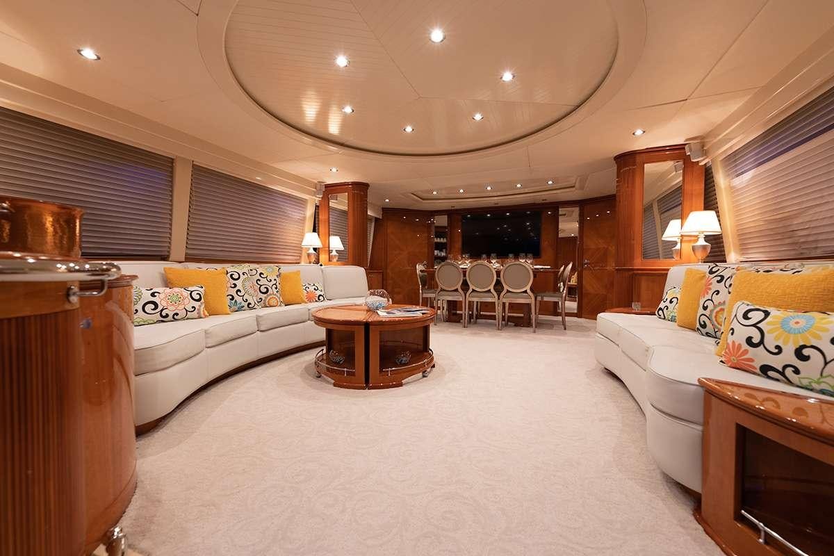 a large living room with a large white bed and a white couch aboard ENDLESS SUN Yacht for Charter