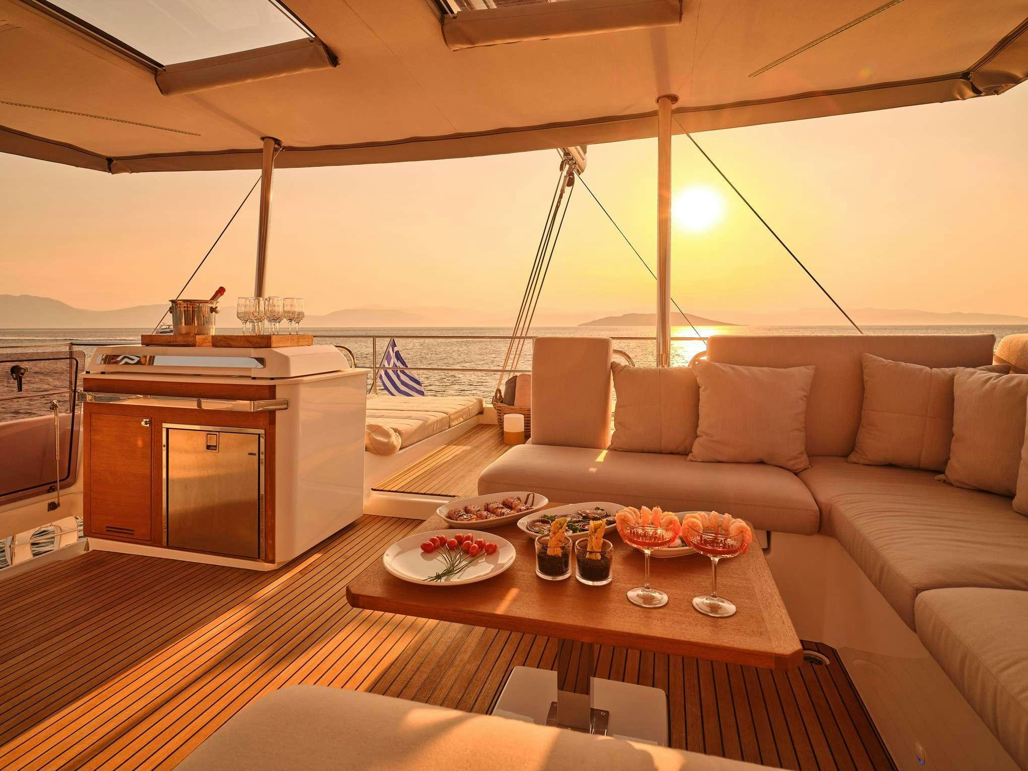 a living room with a couch and a table aboard ALEXANDRA II Yacht for Charter