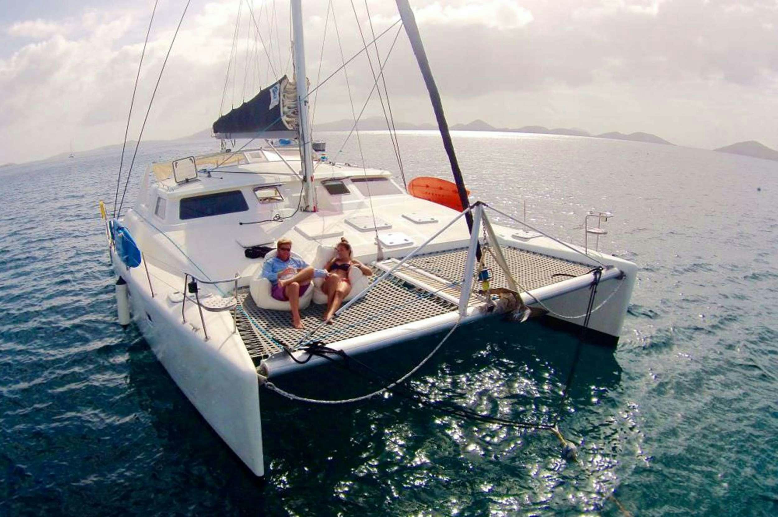 a couple of people on a boat aboard Genesis II Yacht for Charter