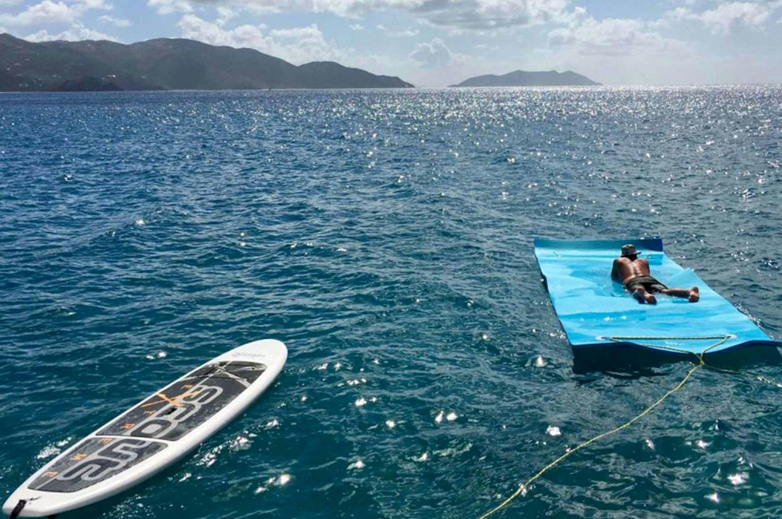a person in a kayak in the water aboard Genesis II Yacht for Charter
