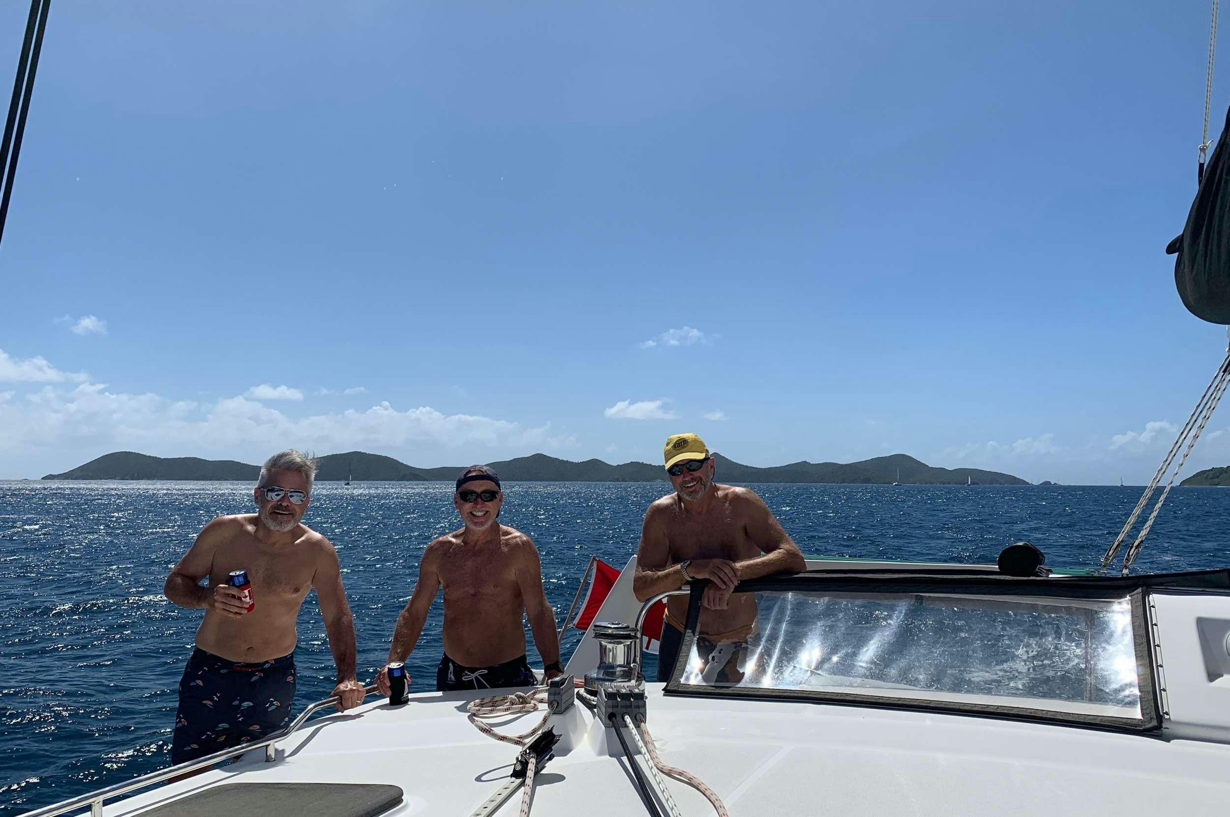 a group of men on a boat aboard Genesis II Yacht for Charter