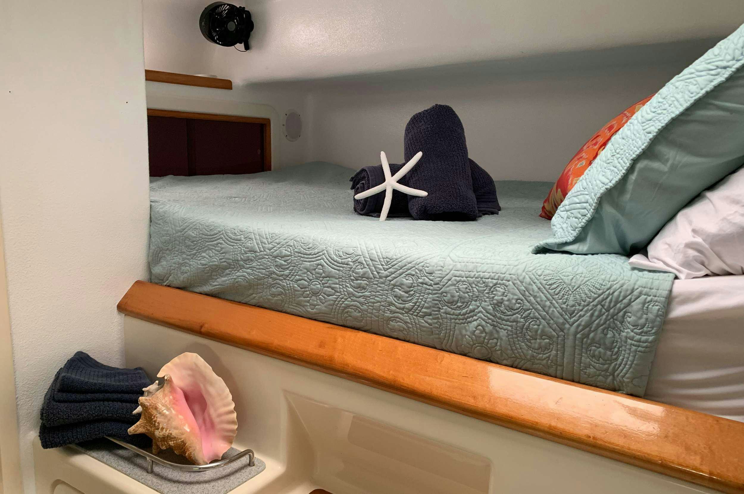 a person lying on a bed aboard Genesis II Yacht for Charter