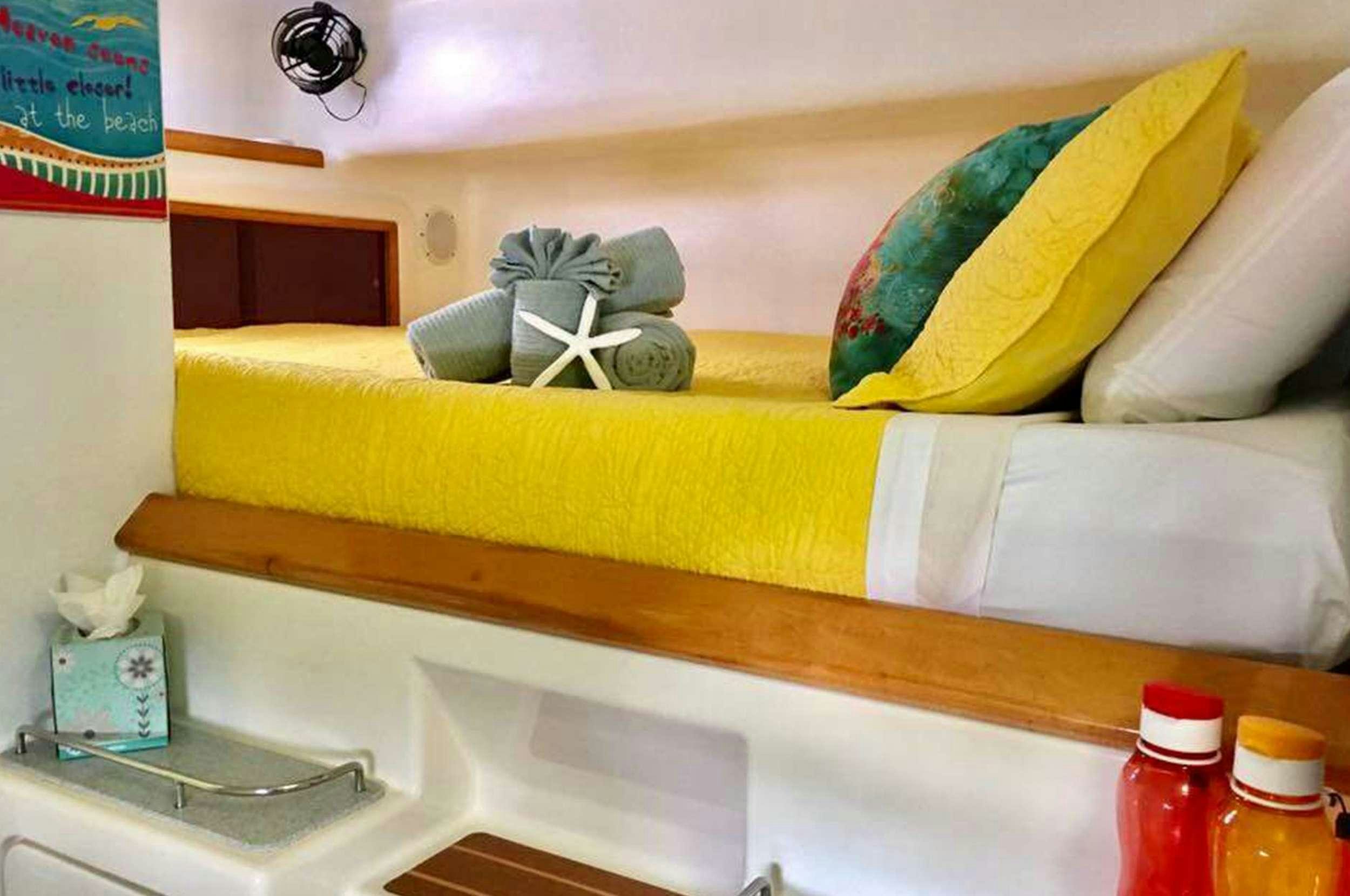 a shelf with a bed and a shelf with objects on it aboard Genesis II Yacht for Charter