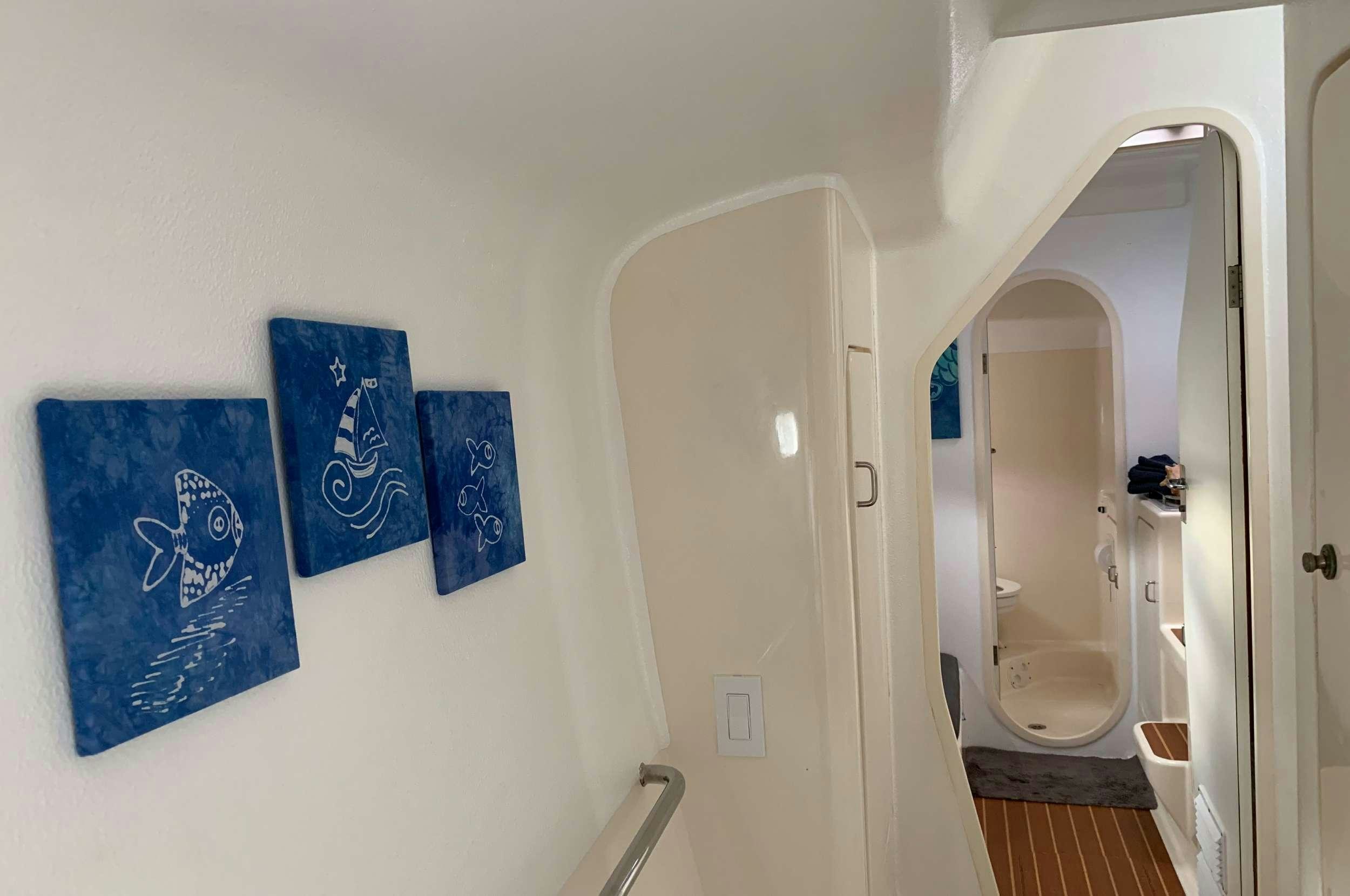 a bathroom with a blue towel on the wall aboard Genesis II Yacht for Charter