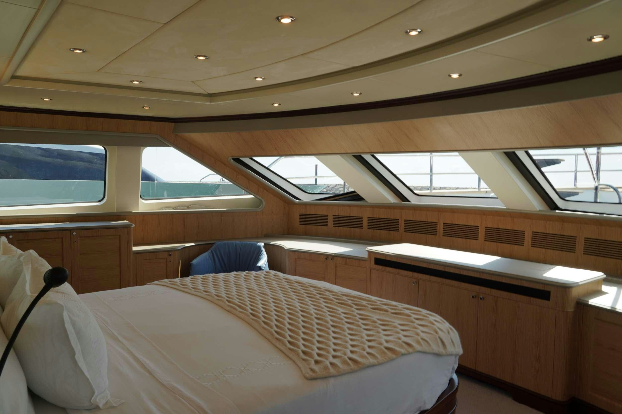 a room with a bed and a desk aboard PAPAITO Yacht for Charter