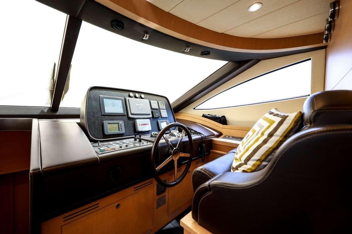inside of a vehicle with a seat and steering wheel aboard JOY Yacht for Charter