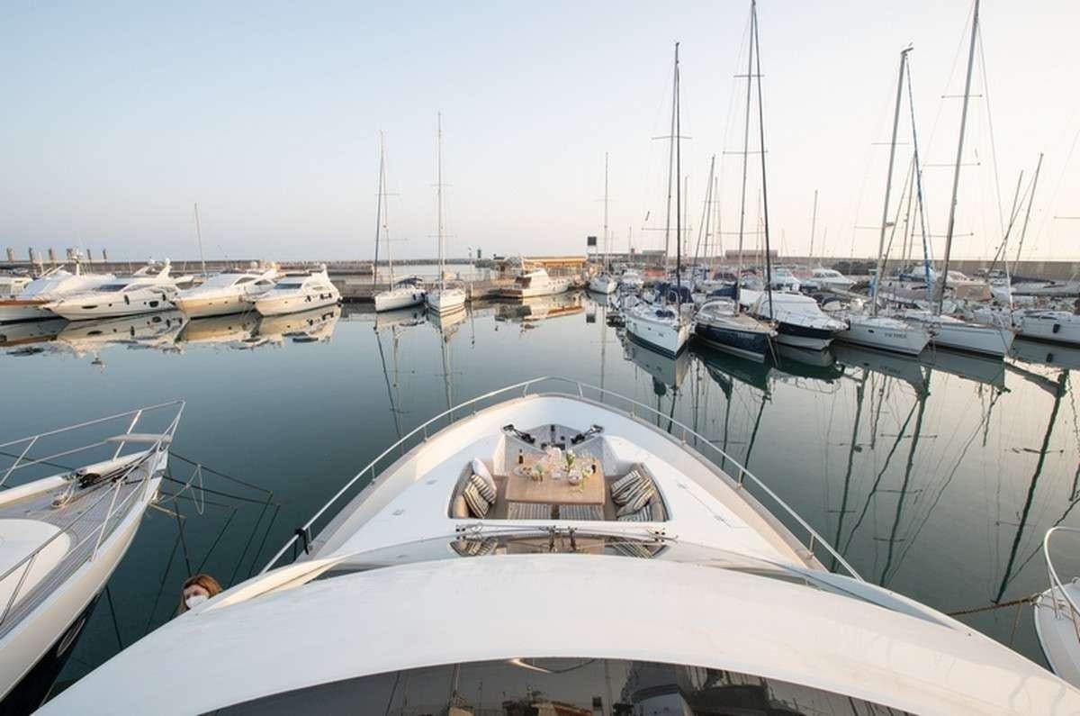 a group of boats are parked in a harbor aboard JOY Yacht for Charter