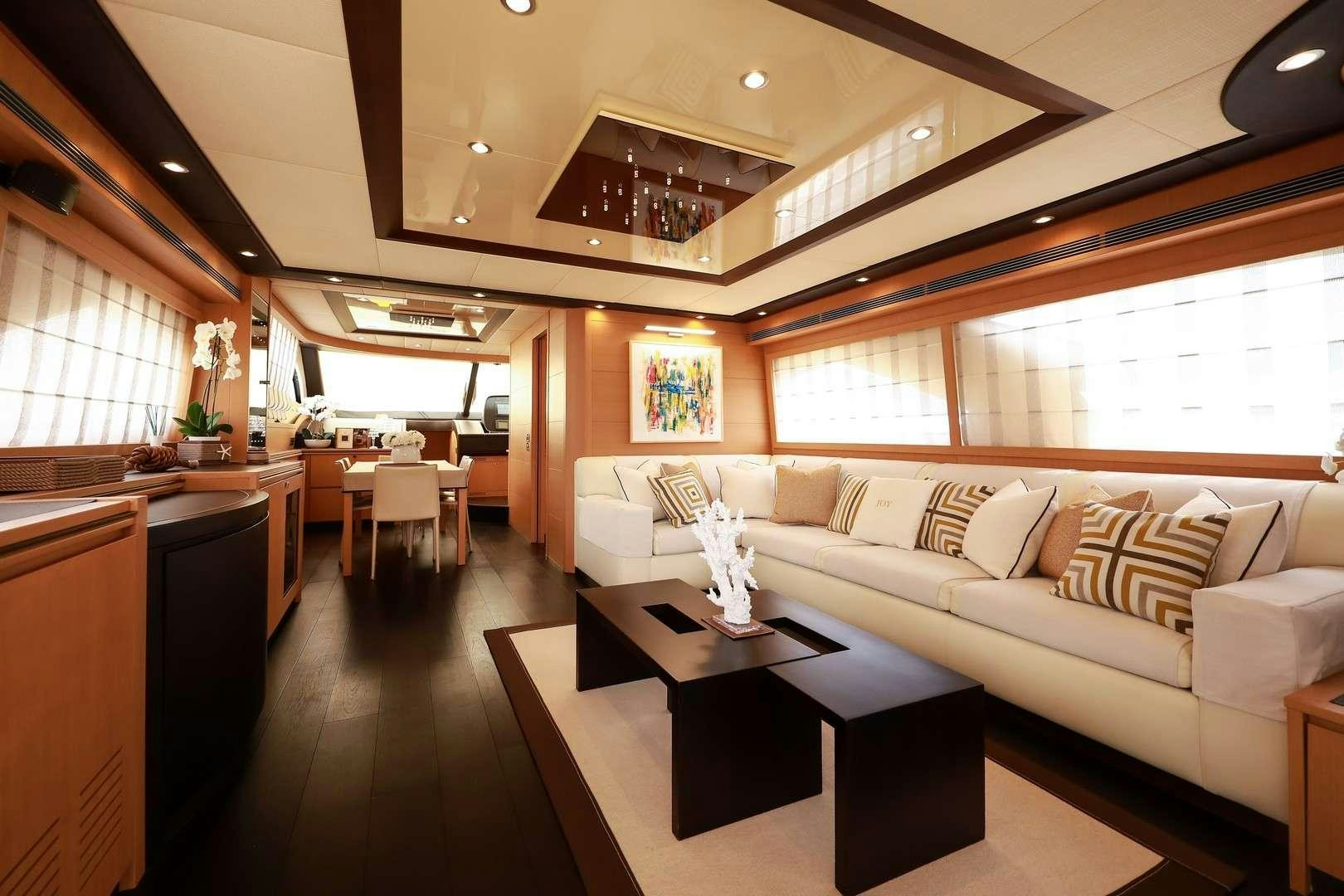 a living room with a couch and a coffee table aboard JOY Yacht for Charter