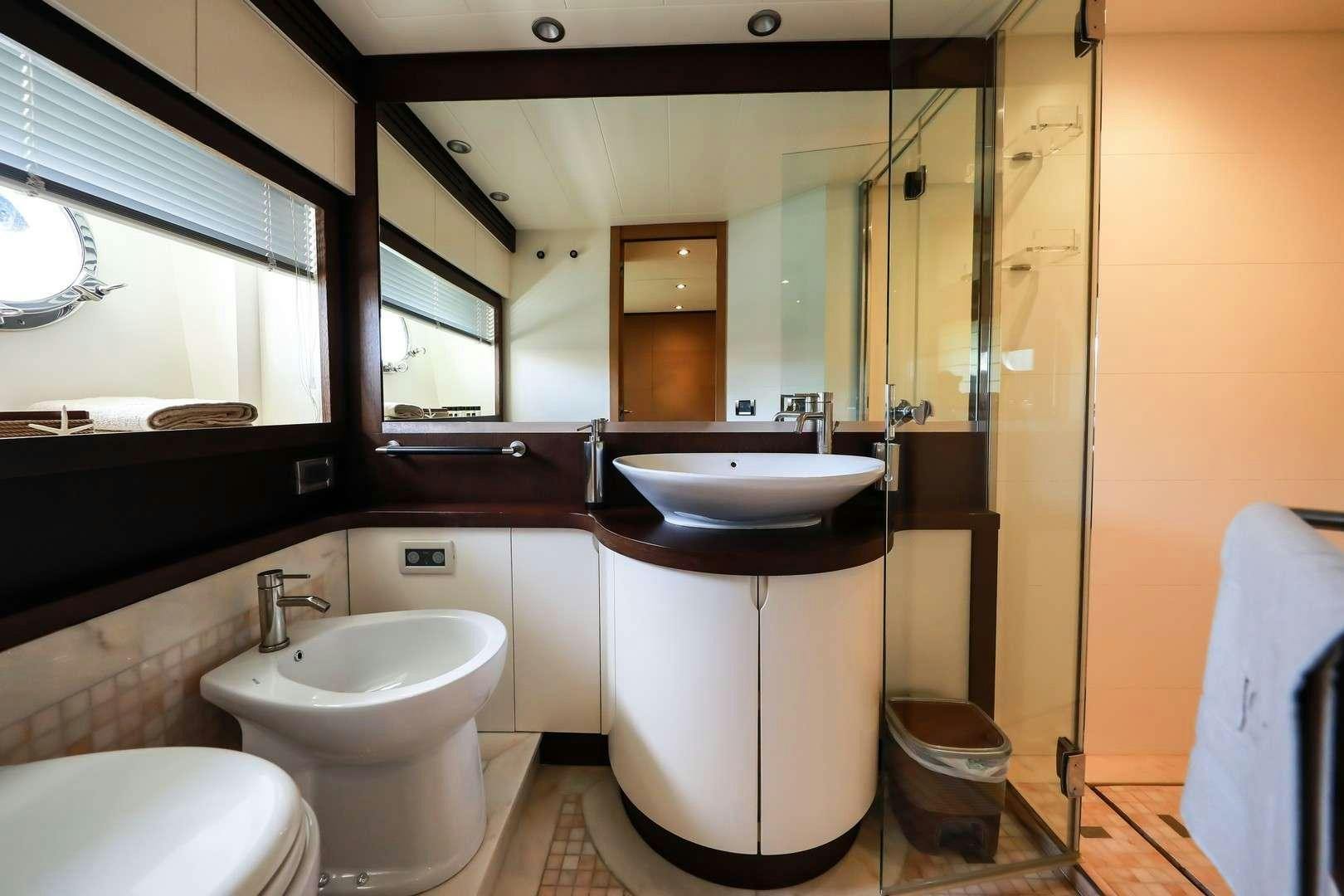 a bathroom with a large mirror aboard JOY Yacht for Charter