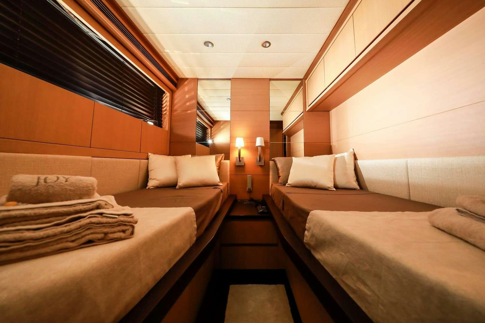 a room with a bed and a couch aboard JOY Yacht for Charter