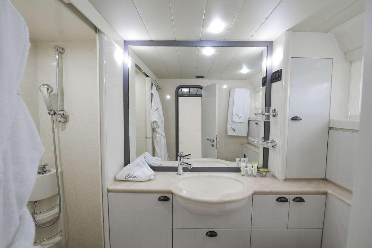 a bathroom with a large mirror aboard Celine Yacht for Charter