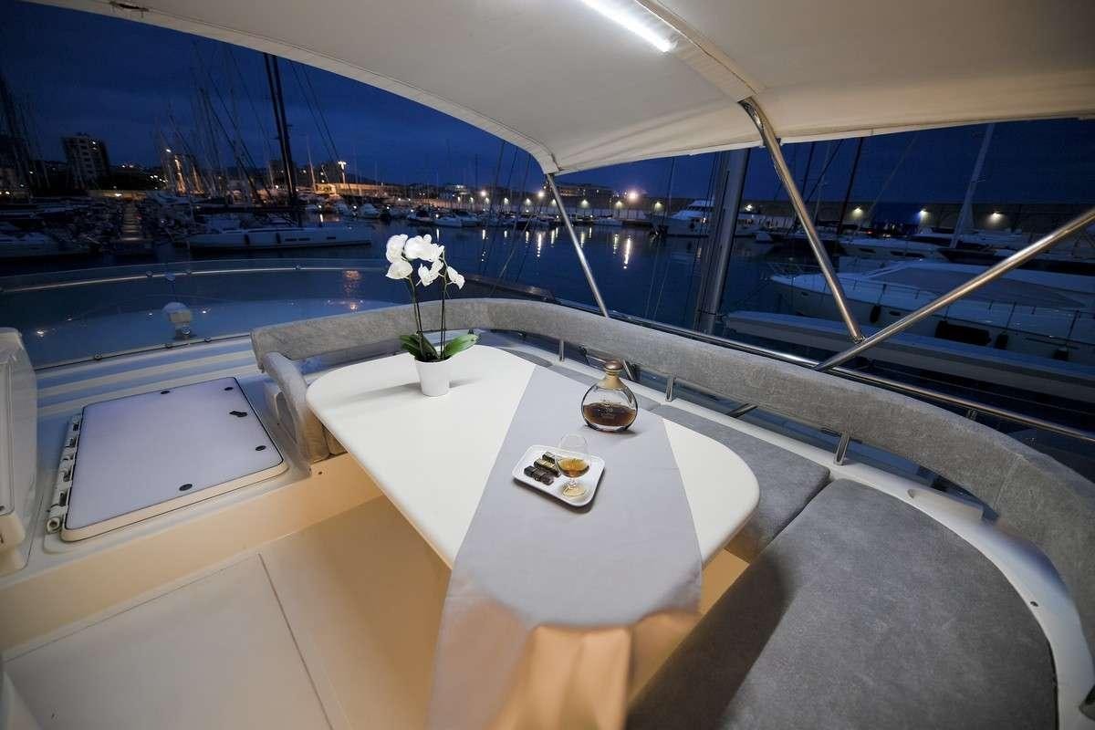 a room with a table and chairs aboard Celine Yacht for Charter