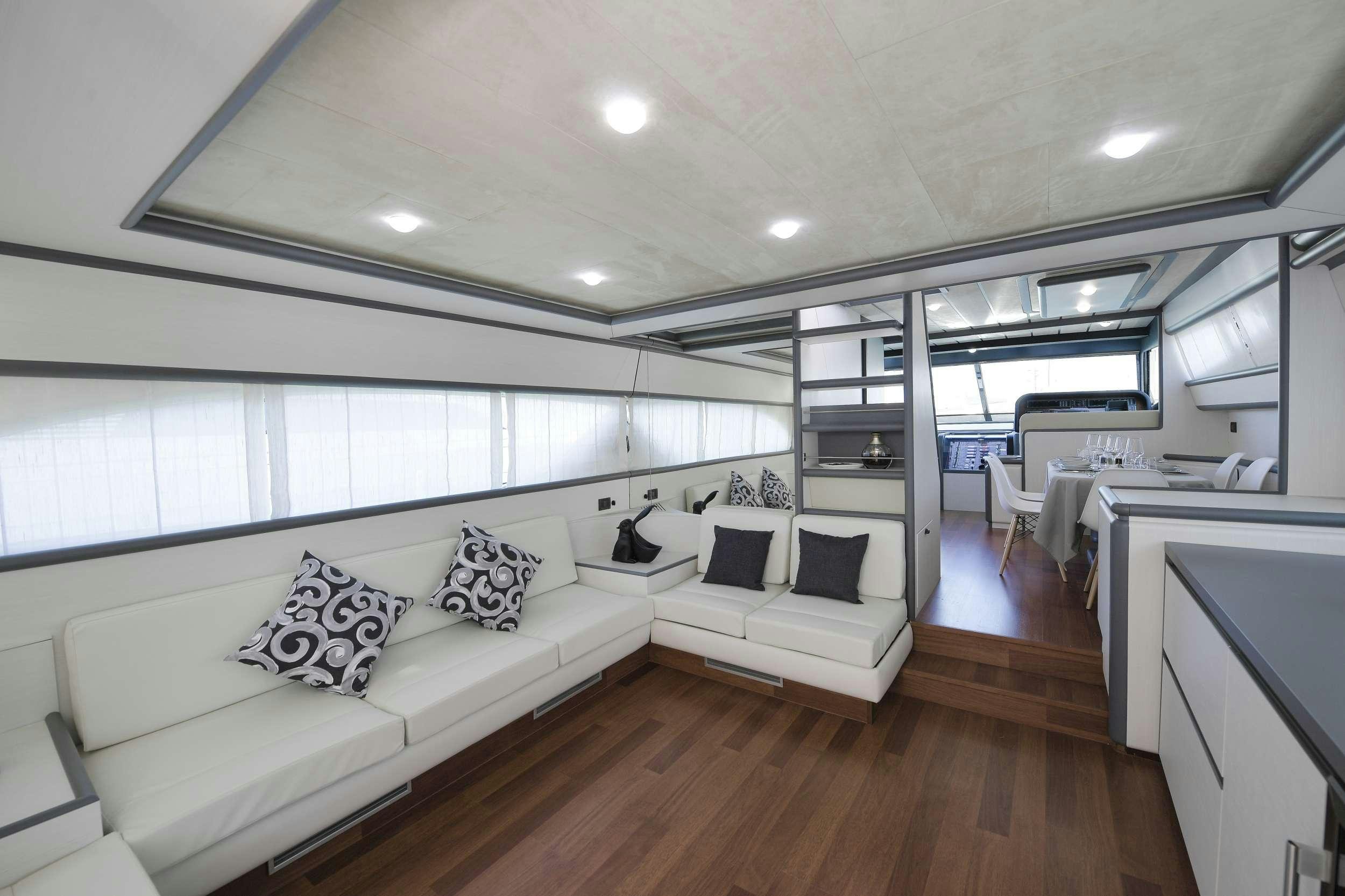 a living room with a couch and a table aboard Celine Yacht for Charter
