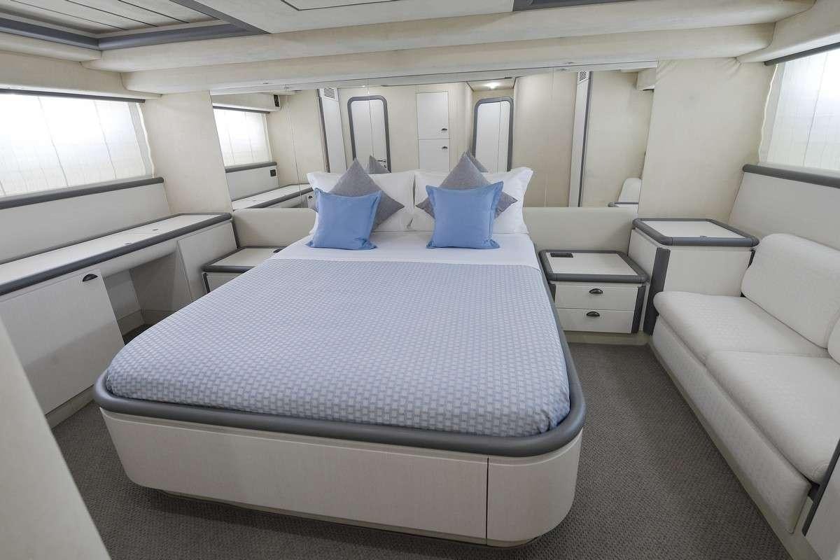 a room with a bed and a couch aboard Celine Yacht for Charter