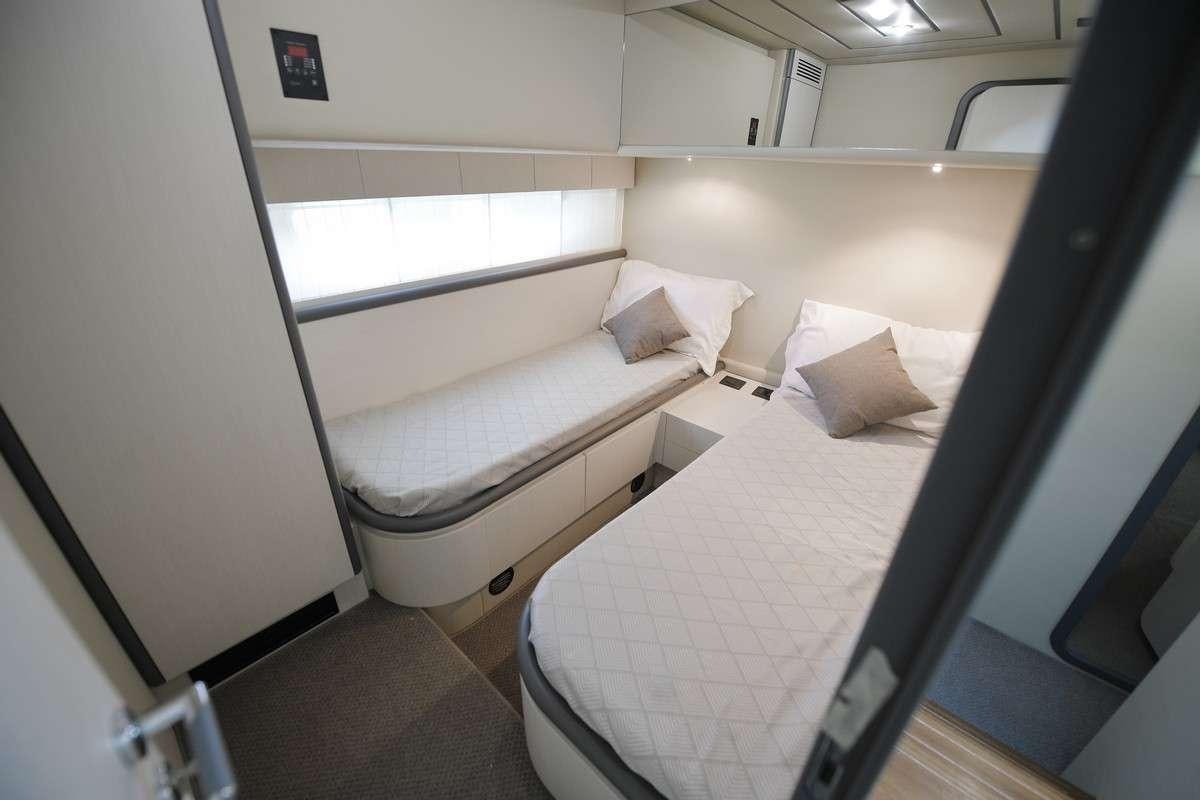 a room with a bed and a window aboard Celine Yacht for Charter