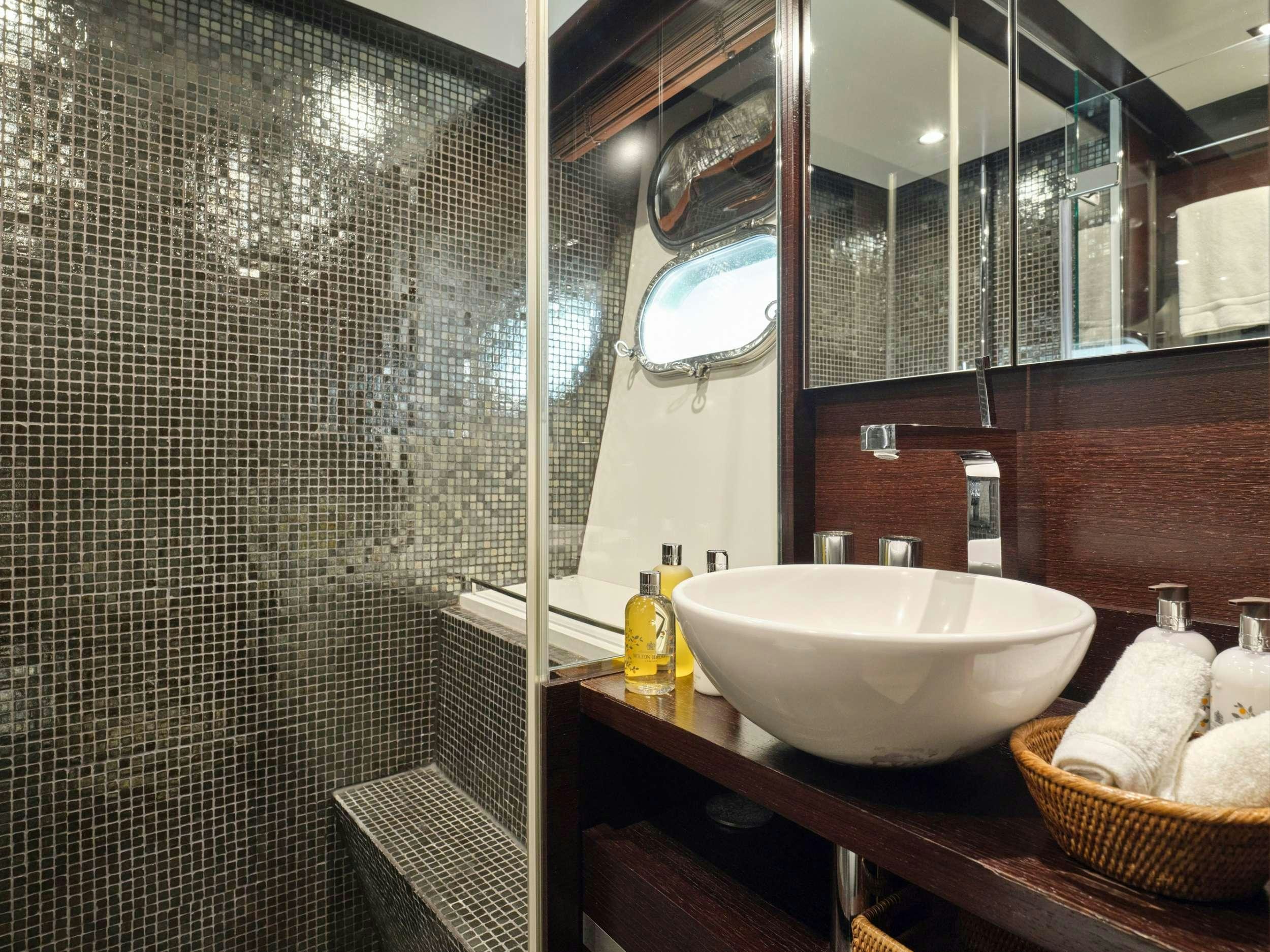 a bathroom with a sink and a mirror aboard HAKUNA MATATA Yacht for Charter